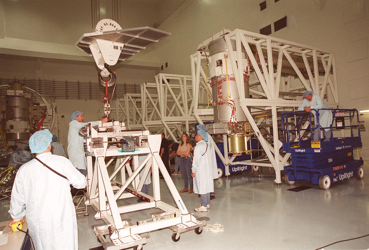 Workers in the Space Station Processing Facility prepare an overhead crane they will use to move a solar array, a component of the International Space Station, for installation onto the Integrated Equipment Assembly. The solar array is the second one being installed. They are scheduled to be launched on mission STS-97 in late November along with the P6 truss. The Station’s electrical power system (EPS) will use eight photovoltaic solar arrays to convert sunlight to electricity. Each of the eight solar arrays will be 112 feet long by 39 feet wide. The solar arrays are mounted on a “blanket” that can be folded like an accordion for delivery. Once in orbit, astronauts will deploy the blankets to their full size. Gimbals will be used to rotate the arrays so that they will face the Sun to provide maximum power to the Space Station