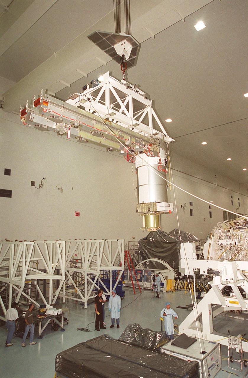 The overhead crane carrying a solar array turns on its axis to move the array to the Integrated Equipment Assembly (IEA) for installation. A component of the International Space Station, the solar array is the second one being installed on the IEA. The arrays are scheduled to be launched on mission STS-97 in late November along with the P6 truss. The Station’s electrical power system (EPS) will use eight photovoltaic solar arrays to convert sunlight to electricity. Each of the eight solar arrays will be 112 feet long by 39 feet wide. The solar arrays are mounted on a “blanket” that can be folded like an accordion for delivery. Once in orbit, astronauts will deploy the blankets to their full size. Gimbals will be used to rotate the arrays so that they will face the Sun to provide maximum power to the Space Station