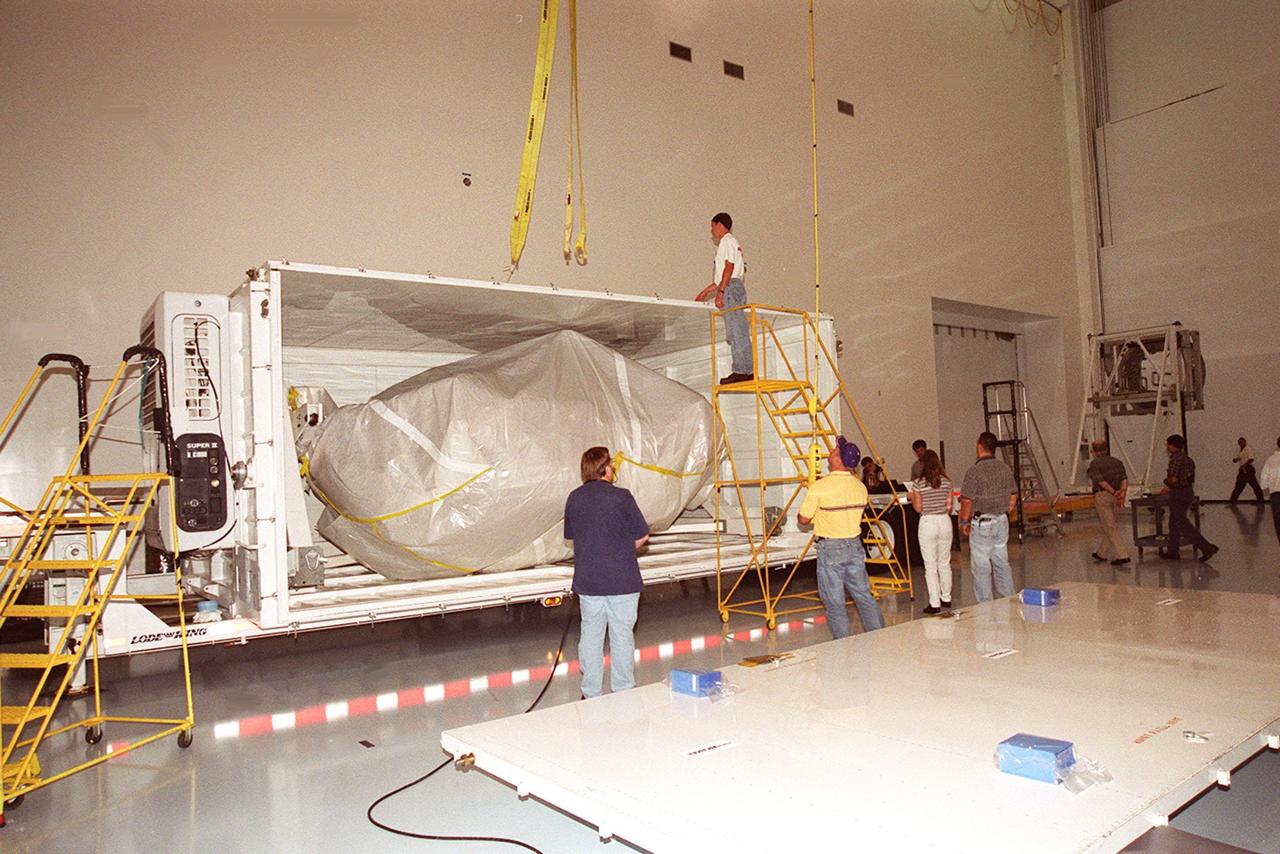 KENNEDY SPACE CENTER, FLA. -- With the lid removed, the wrapped Mobile Base System (MBS) is revealed inside its transport container. The MBS is part of the Canadian Space Agency’s Space Station Remote Manipulator System (SSRMS), which is part of the payload on mission STS-100 to the International Space Station