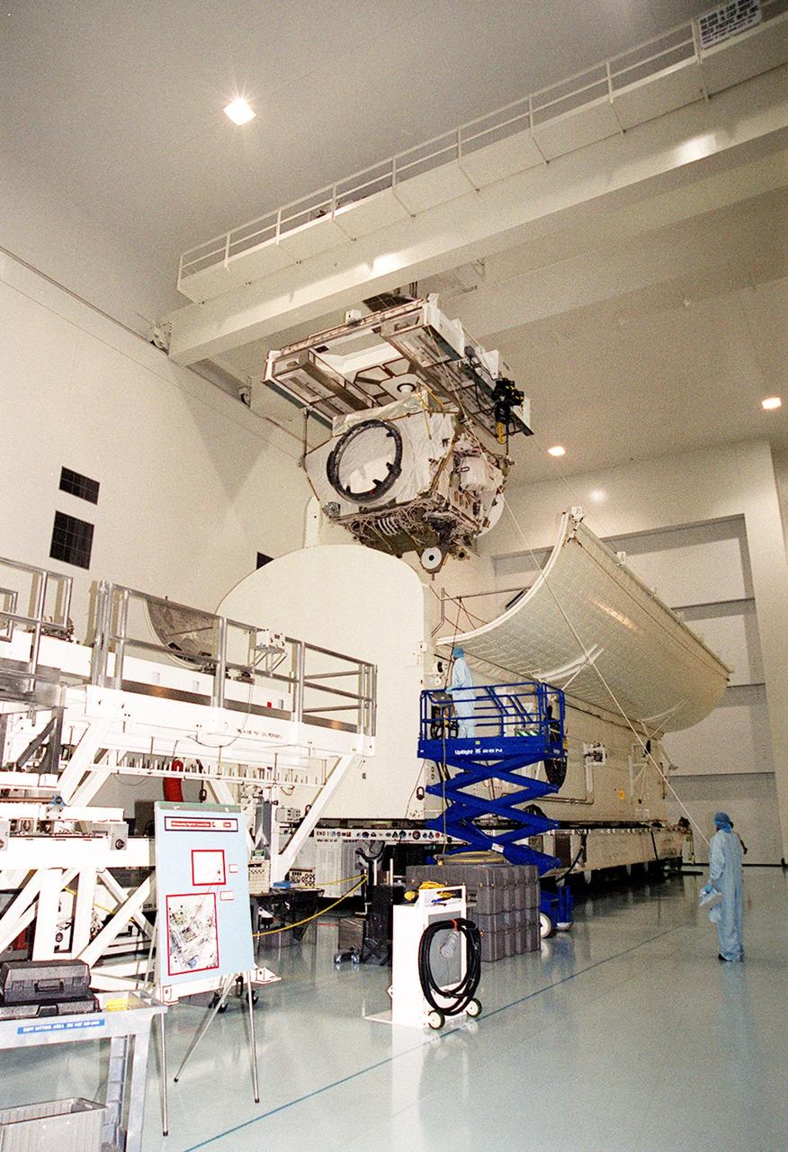 Suspended by an overhead crane in the Space Station Processing Facility, the Integrated Truss Structure Z1 is lowered toward the open doors of the payload canister below. After secured inside, the truss will be transported to Launch Pad 39A. It is part of the payload on mission STS-92 scheduled to lift off Oct. 5, 2000