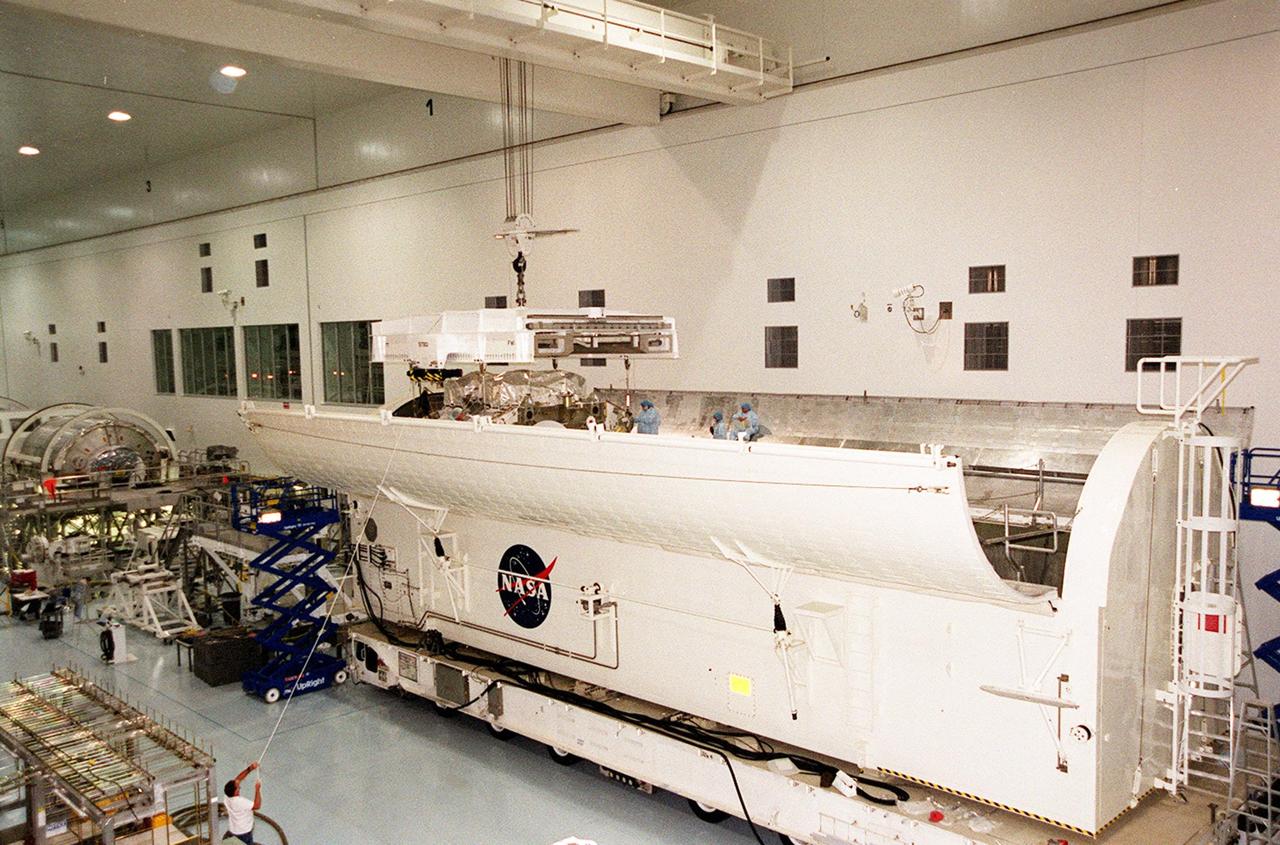 The Integrated Truss Structure Z1 disappears inside the payload canister after being lowered by the overhead crane in the Space Station Processing Facility. Once it is secured inside, the truss will be transported to Launch Pad 39A. It is part of the payload on mission STS-92 scheduled to lift off Oct. 5, 2000