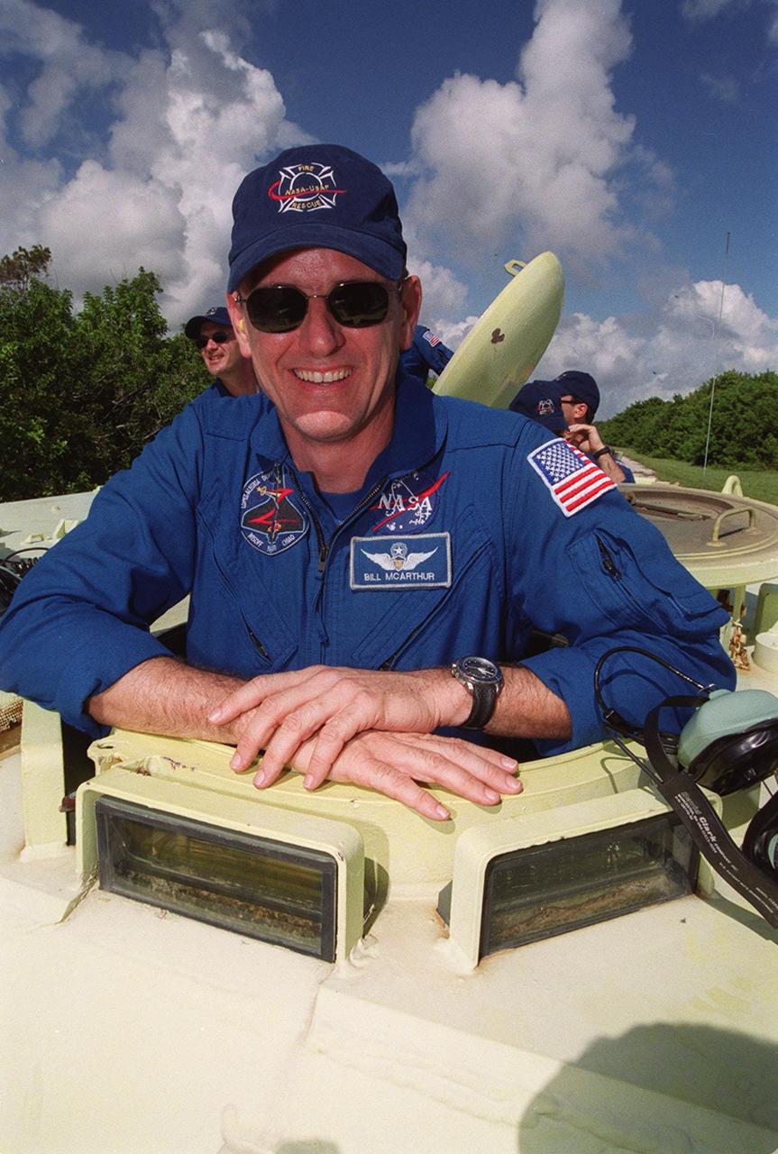 STS-92 Mission Specialist Bill McArthur gets ready to take his turn at driving the M-113, part of emergency egress training during Terminal Countdown Demonstration Test (TCDT) activities. Behind him (left) is Mission Specialist Jeff Wisoff, waiting his turn to drive along with other unidentified crew members.; The tracked vehicle could be used by the crew in the event of an emergency at the pad during which the crew must make a quick exit from the area. The TCDT also provides simulated countdown exercises and opportunities to inspect the mission payloads in the orbiter’s payload bay. STS-92 is scheduled to launch Oct. 5 at 9:30 p.m. EDT on the fifth flight to the International Space Station. It will carry two elements of the Space Station, the Integrated Truss Structure Z1 and the third Pressurized Mating Adapter. The mission is also the 100th flight in the Shuttle program
