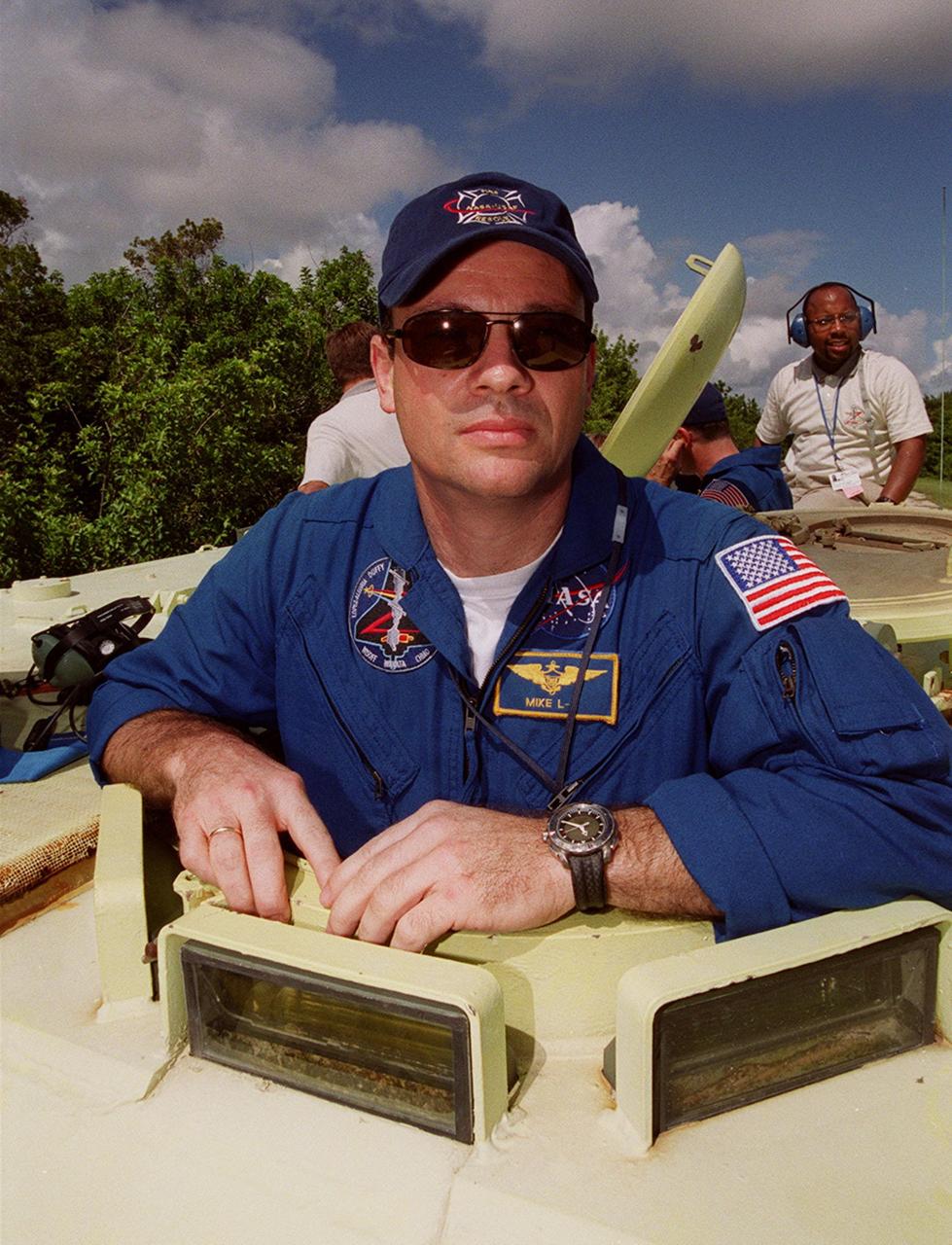 Waiting his turn to drive the M-113 is STS-92 Mission Specialist Michael Lopez-Alegria. Part of emergency egress training during Terminal Countdown Demonstration Test (TCDT) activities, the tracked vehicle could be used by the crew in the event of an emergency at the pad during which the crew must make a quick exit from the area. The TCDT also provides simulated countdown exercises and opportunities to inspect the mission payloads in the orbiter’s payload bay. STS-92 is scheduled to launch Oct. 5 at 9:30 p.m. EDT on the fifth flight to the International Space Station. It will carry two elements of the Space Station, the Integrated Truss Structure Z1 and the third Pressurized Mating Adapter. The mission is also the 100th flight in the Shuttle program