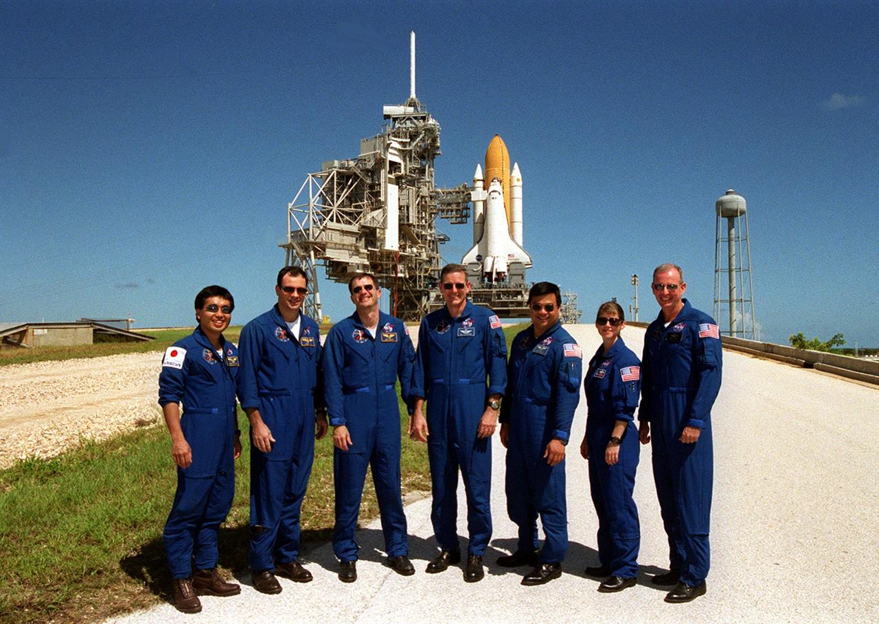 During Terminal Countdown Demonstration Test (TCDT) activities at Launch Pad 39A, the STS-92 crew poses for a group photo. Standing, left to right, on the crawlerway ramp are Mission Specialists Koichi Wakata of Japan, Michael Lopez-Alegria, Jeff Wisoff, Bill McArthur and Leroy Chiao; Pilot Pam Melroy; and Commander Brian Duffy. The TCDT provides emergency egress training, simulated countdown exercises and opportunities to inspect the mission payloads in the orbiter’s payload bay. In the background is Space Shuttle Discovery. STS-92 is scheduled to launch Oct. 5 at 9:30 p.m. EDT on the fifth flight to the International Space Station. It will carry two elements of the Space Station, the Integrated Truss Structure Z1 and the third Pressurized Mating Adapter. The mission is also the 100th flight in the Shuttle program