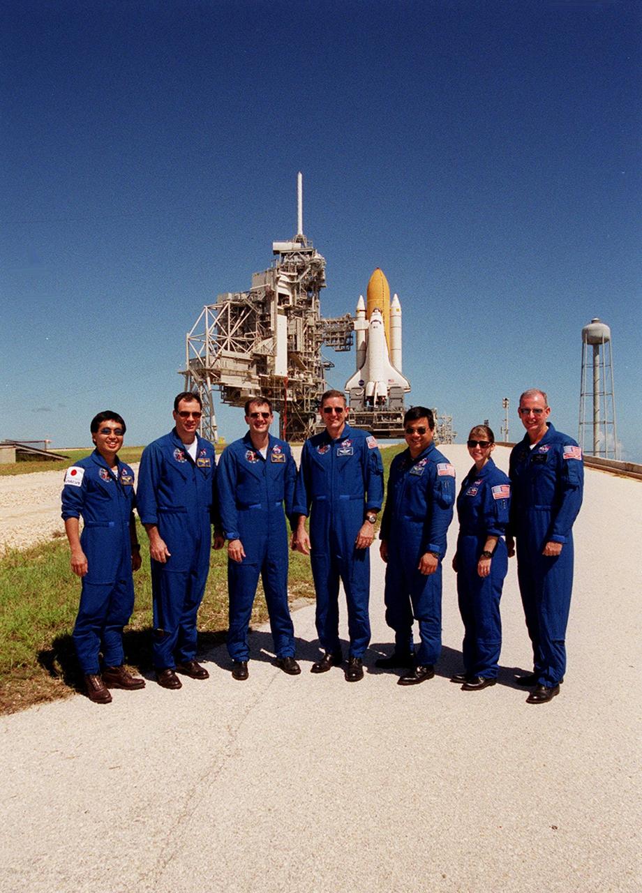 During Terminal Countdown Demonstration Test (TCDT) activities at Launch Pad 39A, the STS-92 crew poses for a group photo. In the background is Space Shuttle Discovery. Standing, left to right, on the crawlerway ramp are Mission Specialists Koichi Wakata of Japan, Michael Lopez-Alegria, Jeff Wisoff, Bill McArthur and Leroy Chiao; Pilot Pam Melroy; and Commander Brian Duffy. The TCDT provides emergency egress training, simulated countdown exercises and opportunities to inspect the mission payloads in the orbiter’s payload bay. STS-92 is scheduled to launch Oct. 5 at 9:30 p.m. EDT on the fifth flight to the International Space Station. It will carry two elements of the Space Station, the Integrated Truss Structure Z1 and the third Pressurized Mating Adapter. The mission is also the 100th flight in the Shuttle program