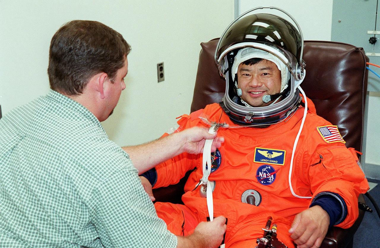 In the Operations and Checkout Building, STS-92 Mission Specialist Leroy Chiao has his launch and entry suit adjusted during fit check. Chiao and the rest of the crew are at KSC for Terminal Countdown Demonstration Test activities. The TCDT provides emergency egress training, simulated countdown exercises and opportunities to inspect the mission payload. This mission will be Chiao’s third Shuttle flight. STS-92 is scheduled to launch Oct. 5 at 9:38 p.m. EDT from Launch Pad 39A on the fifth flight to the International Space Station. It will carry two elements of the Space Station, the Integrated Truss Structure Z1 and the third Pressurized Mating Adapter. The mission is also the 100th flight in the Shuttle program