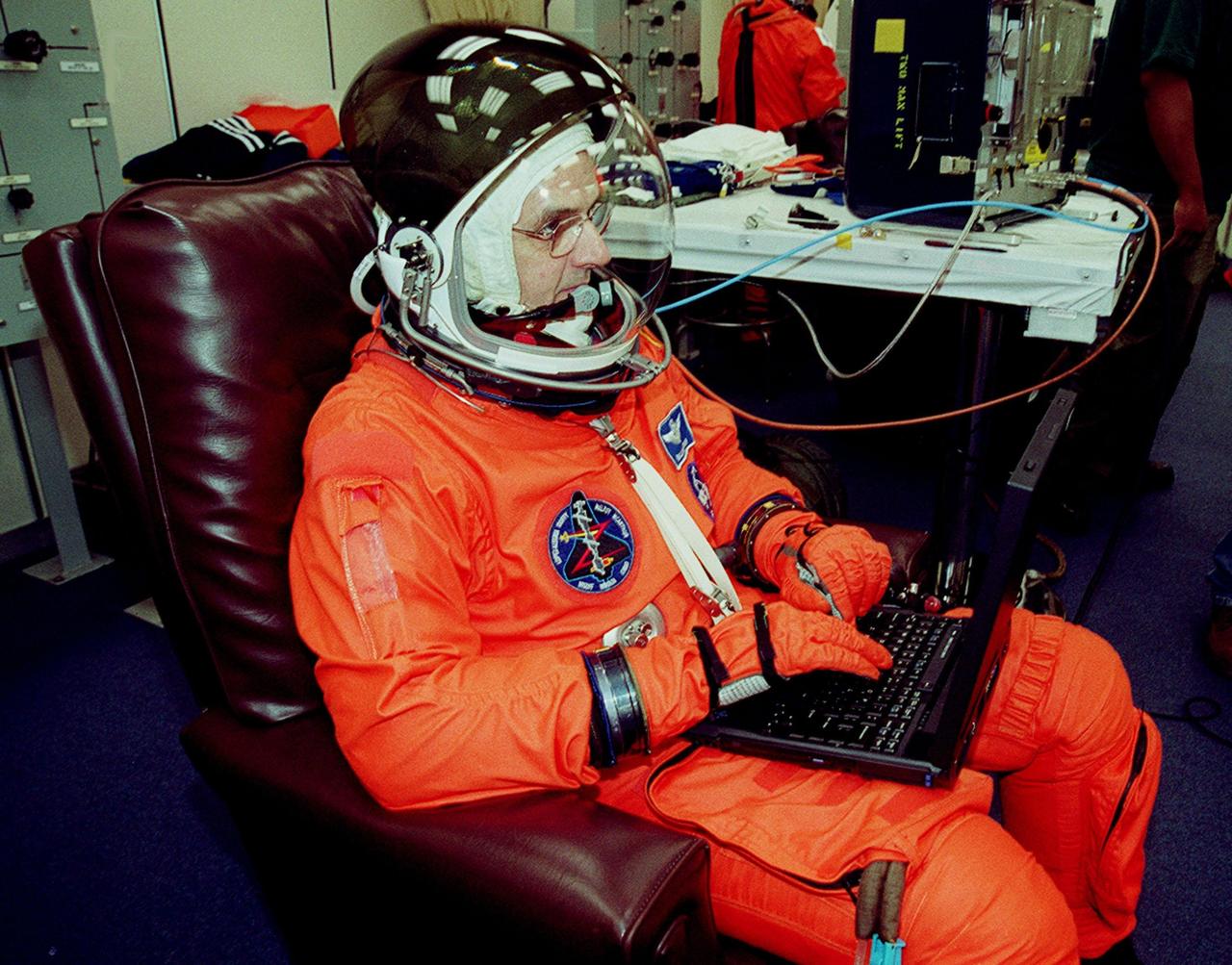 During pre-pack and fit check in the Operations and Checkout Building, STS-92 Mission Specialist William S. McArthur Jr. uses a laptop computer while garbed in his full launch and entry suit. McArthur and the rest of the crew are at KSC for Terminal Countdown Demonstration Test activities. The TCDT provides emergency egress training, simulated countdown exercises and opportunities to inspect the mission payload. This mission will be McArthur’s third Shuttle flight. STS-92 is scheduled to launch Oct. 5 at 9:38 p.m. EDT from Launch Pad 39A on the fifth flight to the International Space Station. It will carry two elements of the Space Station, the Integrated Truss Structure Z1 and the third Pressurized Mating Adapter. The mission is also the 100th flight in the Shuttle program