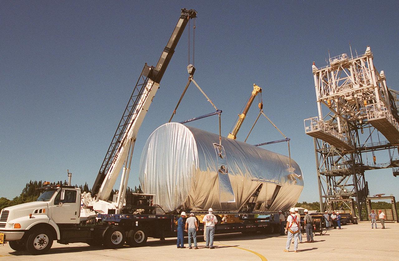 KENNEDY SPACE CENTER, FLA. -- At the KSC Shuttle Landing Facility, the  Joint Airlock Module, the gateway from which crew members aboard the International Space Station (ISS) will enter and exit the 470-ton orbiting research facility, is settled onto a flatbed trailer for transport to the Operations and Checkout Building in the KSC industrial area. There it will undergo vacuum chamber testing. It will then be moved to the Space Station Processing Facility (SSPF) for further prelaunch preparation and checkout. The massive, spindle-shaped airlock is 20 feet long, has a diameter of 13 feet at its widest point, and weighs six and a half tons. It was manufactured at NASA's Marshall Space Flight Center by the Huntsville division of The Boeing Company. The Space Shuttle Atlantis will carry the airlock to orbit on mission STS-104, the tenth International Space Station flight, currently targeted for liftoff in May 2001