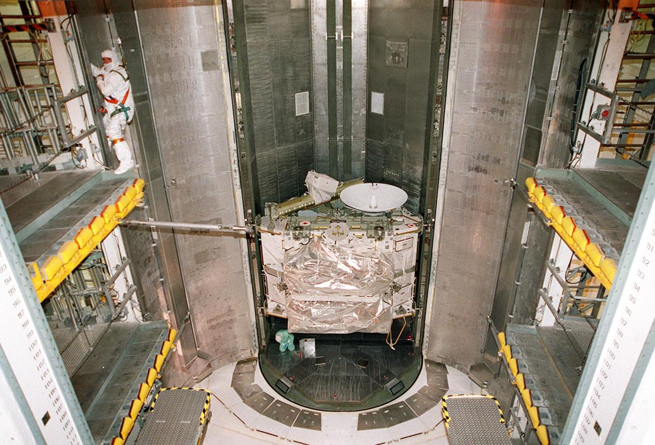 Inside the Payload Changeout Room (PCR), workers prepare to move the Integrated Truss Structure Z1 out of the payload canister. Once inside the PCR, workers will get ready to move the Z1 into the payload bay of Space Shuttle Discovery. The Z1 truss is the first of 10 that will become the backbone of the International Space Station, eventually stretching the length of a football field. Along with its companion payload, the third Pressurized Mating Adapter, the Z1 is scheduled to be launched aboard Discovery Oct. 5 at 9:38 p.m. EDT
