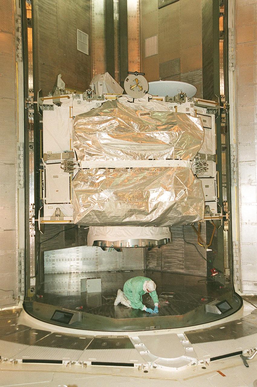 Inside the Payload Changeout Room (PCR), a worker makes sure the Integrated Truss Structure Z1 is ready to be moved into the payload bay of Space Shuttle Discovery. The Z1 truss is the first of 10 that will become the backbone of the International Space Station, eventually stretching the length of a football field. Along with its companion payload, the third Pressurized Mating Adapter, the Z1 is scheduled to be launched aboard Discovery Oct. 5 at 9:38 p.m. EDT