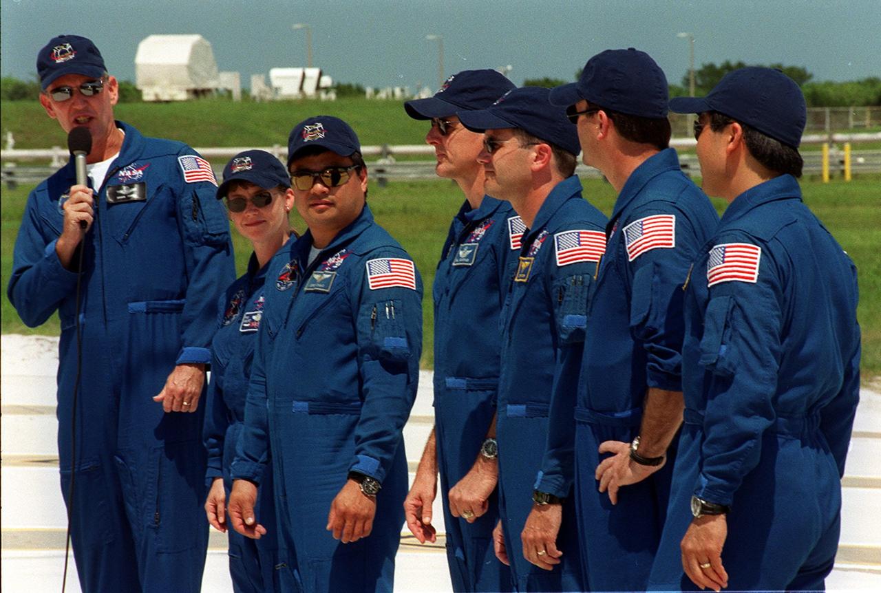 KENNEDY SPACE CENTER, FLA. -- At Launch Pad 39A during a question and answer session with the media, STS-92 Commander Brian Duffy talks about the mission. Standing next to him, left to right, are Pilot Pamela Ann Melroy and Mission Specialists Leroy Chiao, William S. McArthur Jr., Peter J.K. “Jeff” Wisoff, Michael E. Lopez-Alegria and Koichi Wakata of Japan. The crew is at KSC for Terminal Countdown Demonstration Test activities that provide emergency egress training, opportunities to inspect the mission payload, and a simulated countdown. The slidewire basket area is a landing site for the crew if they have to use the slidewire baskets to exit the orbiter on the pad in an emergency. STS-92 is scheduled to launch Oct. 5 at 9:38 p.m. EDT on the fifth flight to the International Space Station. It will carry two elements of the Space Station, the Integrated Truss Structure Z1 and the third Pressurized Mating Adapter. The mission is also the 100th flight in the Shuttle program