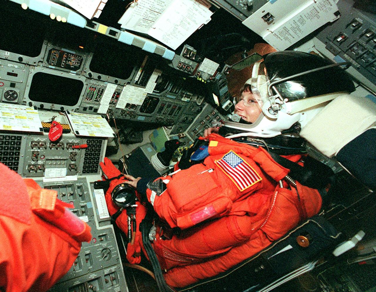 KENNEDY SPACE CENTER, FLA. -- STS-92 Pilot Pamela Ann Melroy gets settled in her seat in Discovery to take part in a simulated countdown. The countdown is part of Terminal Countdown Demonstration Test (TCDT) activities that she and other crew members have been performing. STS-92 is scheduled to launch Oct. 5 at 9:38 p.m. EDT on the fifth flight to the International Space Station. It will carry two elements of the Space Station, the Integrated Truss Structure Z1 and the third Pressurized Mating Adapter. The mission is also the 100th flight in the Shuttle program