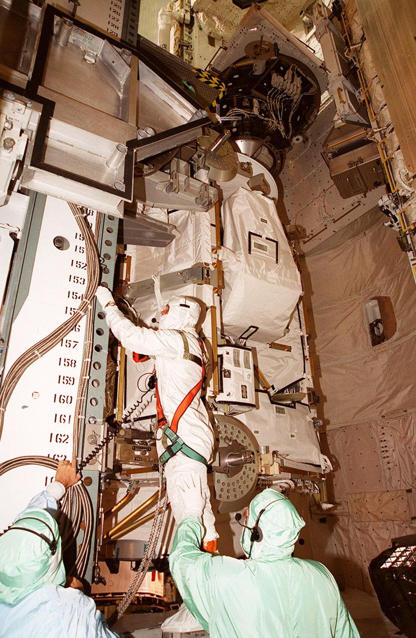 A worker in the Payload Changeout Room of Launch Pad 39A makes a final check on the Integrated Truss Structure Z1 waiting to be moved into the payload bay of Discovery. The Z1 is the first of 10 trusses to be installed on the International Space Station. The truss will allow the first U.S. solar arrays on flight 4A, scheduled for Nov. 30, to be temporarily installed on Unity for early power. Space Shuttle Discovery is scheduled for launch on Oct. 5 at 9:38 p.m. EDT. It will be the 100th flight in the Shuttle program