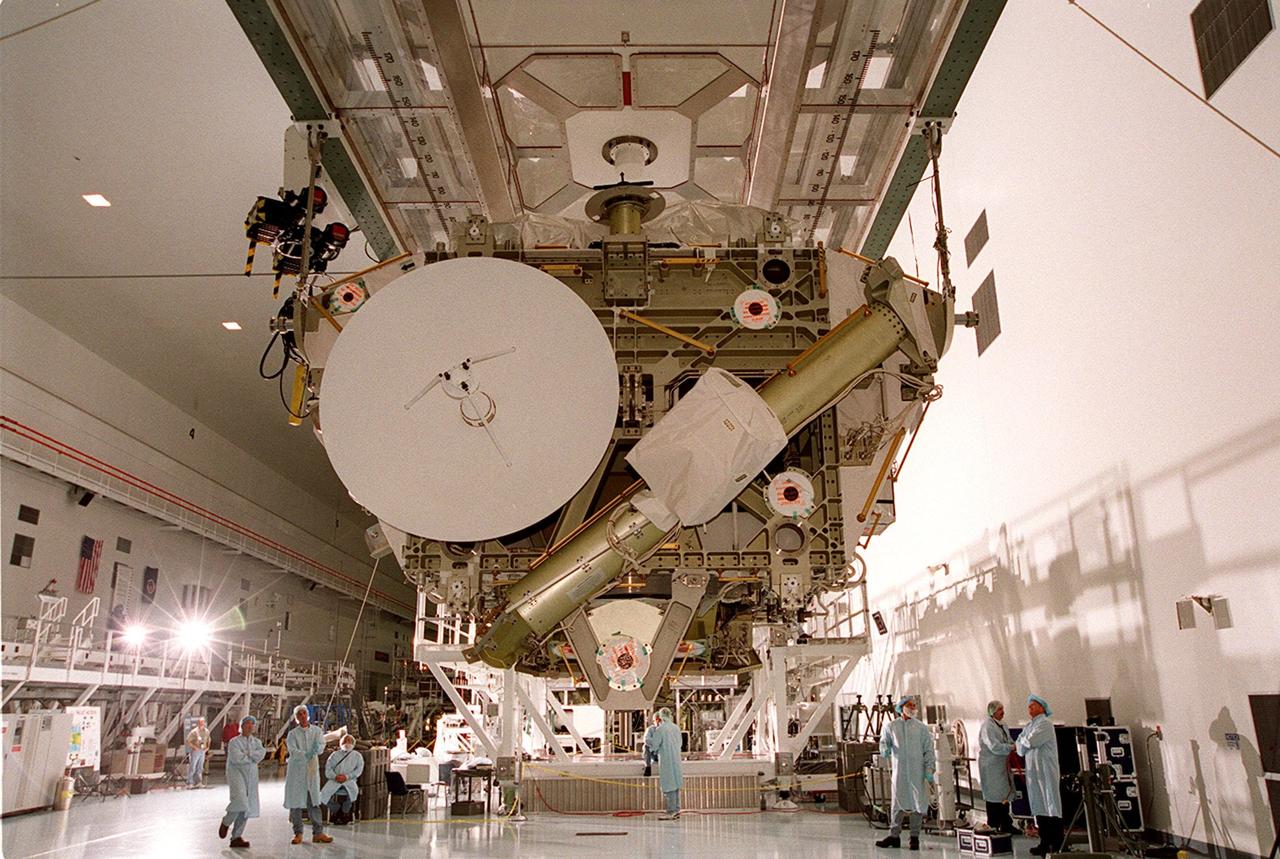 In the Space Station Processing Facility, workers watch as the Integrated Truss Structure Z1, an element of the International Space Station, is moved to another stand to check its weight and balance. The Z1 truss is the first of 10 trusses that will become the backbone of the Space Station, eventually stretching the length of a football field. Along with its companion payload, the third Pressurized Mating Adapter, the Z1 is scheduled to be launched aboard Space Shuttle Discovery Oct. 5 at 9:38 p.m. EDT. The launch will be the 100th in the Shuttle program