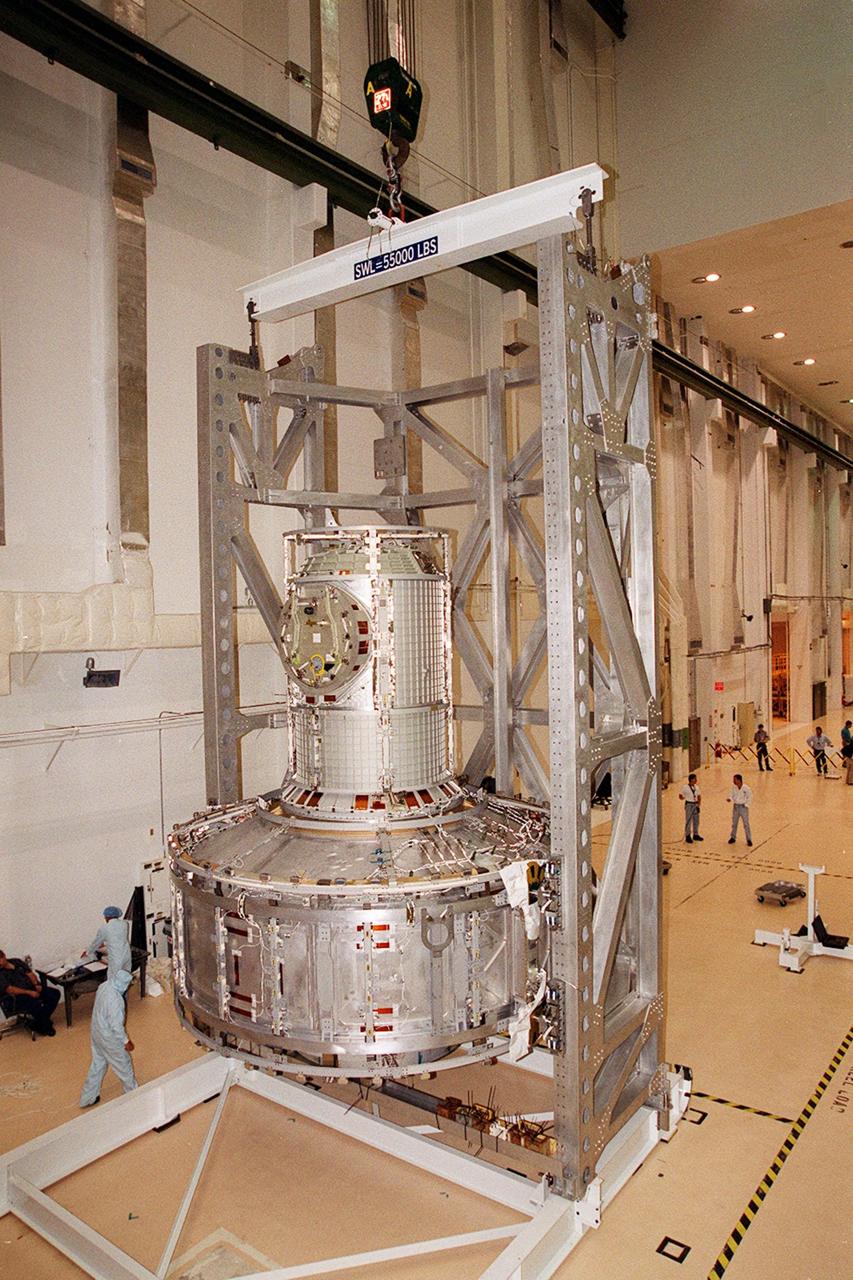 In the Operations and Checkout Building, the Joint Airlock Module, now in vertical position, is ready to be moved into a vacuum chamber for testing. The module is the gateway from which crew members aboard the International Space Station (ISS) will enter and exit the 470-ton orbiting research facility. The airlock is a critical element of the ISS because of design differences between American and Russian spacesuits. The Joint Airlock Module is specially designed to accommodate both suits, providing a chamber where astronauts from every nation can suit up for space walks to conduct maintenance and construction work or to do science experiments outside the Station. The Space Shuttle Atlantis will carry the airlock to orbit on mission STS-104, the 10th International Space Station flight, currently targeted for liftoff in May 2001. The Shuttle crew will secure the airlock to the right side of Unity, the American-built connecting node that currently comprises one-third of the current Space Station, along with the Russian modules Zarya and Zvezda