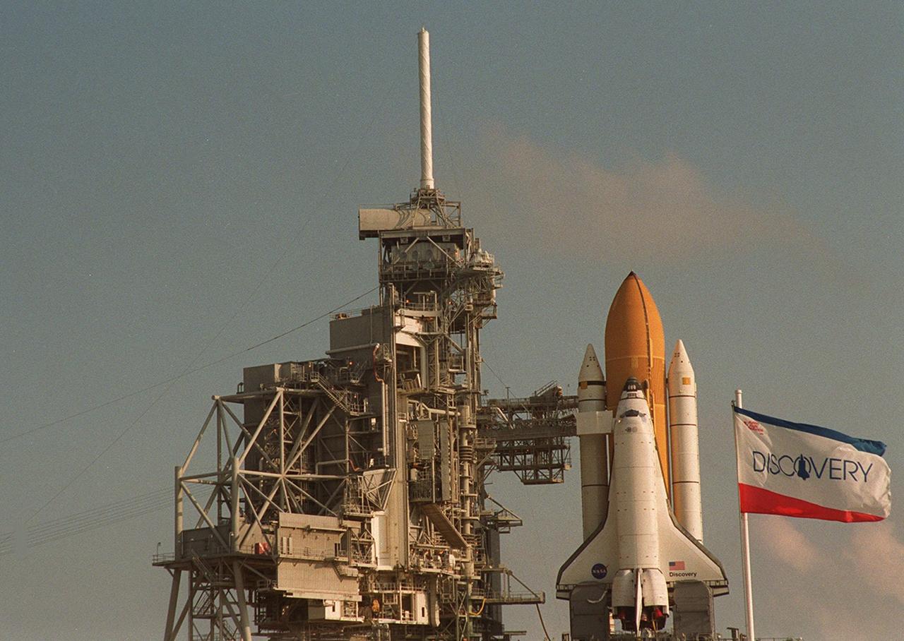 KENNEDY SPACE CENTER, FLA. -- The flag at right identifies Space Shuttle Discovery on Launch Pad 39A after its rollout and before the Rotating Service Structure is moved around it. Scheduled to launch Oct. 5 at 9:38 p.m. EDT on mission STS-92, Discovery will be making the 100th Space Shuttle mission launched from Kennedy Space Center. Discovery also will be making its 28th flight into space, more than any of the other orbiters to date. STS-92 is a mission to the International Space Station, carrying the Z1 truss, which is the first of 10 trusses on the Station, and the third Pressurized Mating Adapter