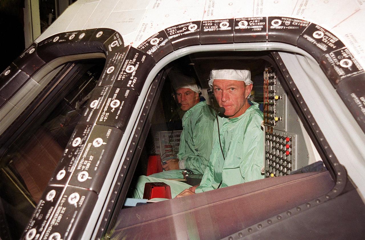 In Orbiter Processing Facility bay 2 during a Crew Equipment Interface Test (CEIT), STS-97 Pilot Michael Bloomfied (left) and Commander Brent Jett (right) check out the cockpit of orbiter Endeavour as part of preflight preparations. The CEIT provides an opportunity for crew members to check equipment and facilities that will be on board the orbiter during their mission. The STS-97 mission will be the sixth construction flight to the International Space Station. The payload includes a photovoltaic (PV) module, providing solar power to the Station. STS-97 is scheduled to launch Nov. 30 from KSC for the 10-day mission