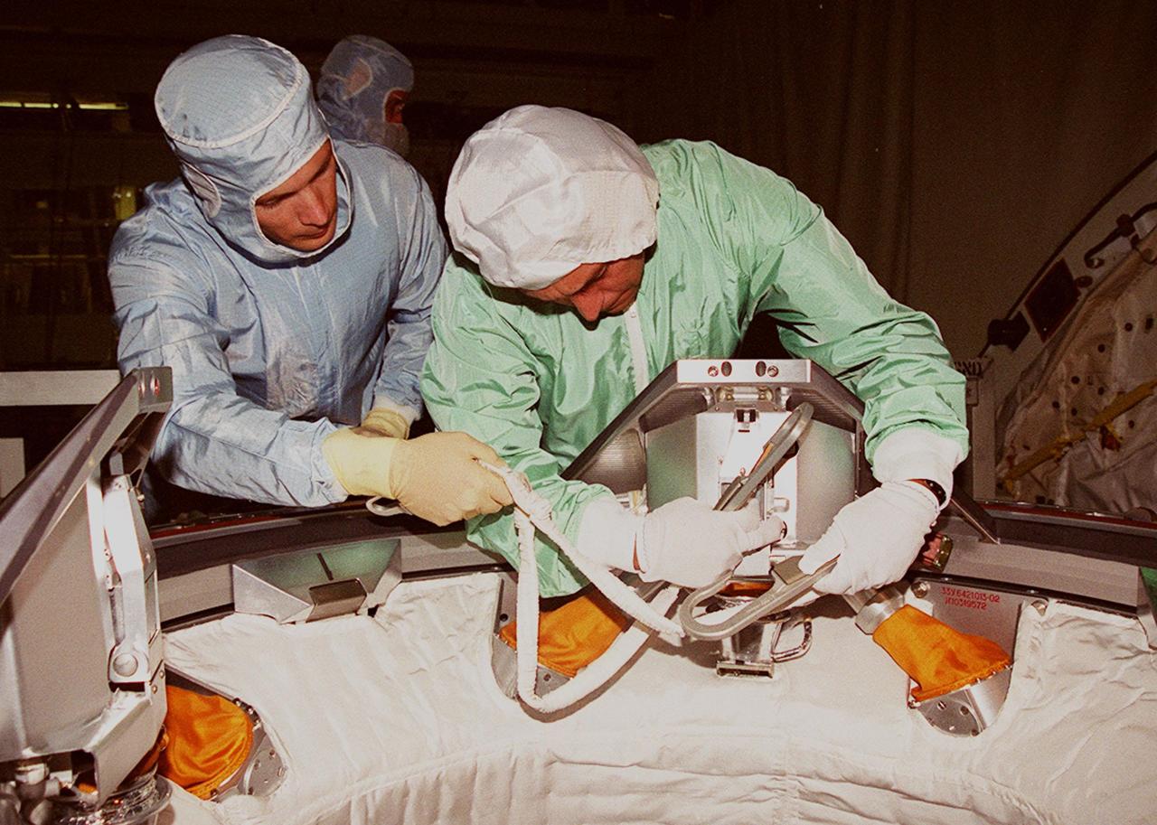 During the STS-97 Crew Equipment Interface Test (CEIT), Mission Specialist Carlos Noriega (right) gets hands-on experience with parts of the Orbital Docking System in Endeavour’s payload bay. The CEIT provides an opportunity for crew members to check equipment and facilities that will be on board the orbiter during their mission. The STS-97 mission will be the sixth construction flight to the International Space Station. The payload includes a photovoltaic (PV) module, providing solar power to the Station. STS-97 is scheduled to launch Nov. 30 from KSC for the 10-day mission