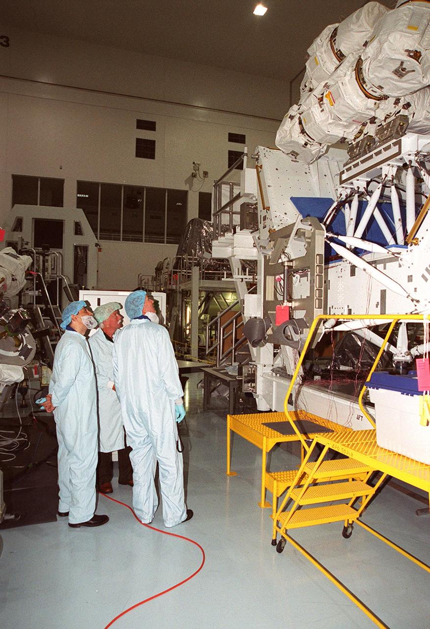 During Crew Equipment Interface Test activities, STS-100 crew members look over the Space Station Remote Manipulator System (SSRMS), also known as the Canadian arm, seated high on a work station. The SSRMS is the primary means of transferring payloads between the orbiter payload bay and the International Space Station for assembly. The 56-foot-long robotic arm includes two 12-foot booms joined by a hinge. Seven joints on the arm allow highly flexible and precise movement. Mission STS-100 is scheduled to launch April 19, 2001, carrying the SSRMS and Raffaello, a multi-purpose logistics module