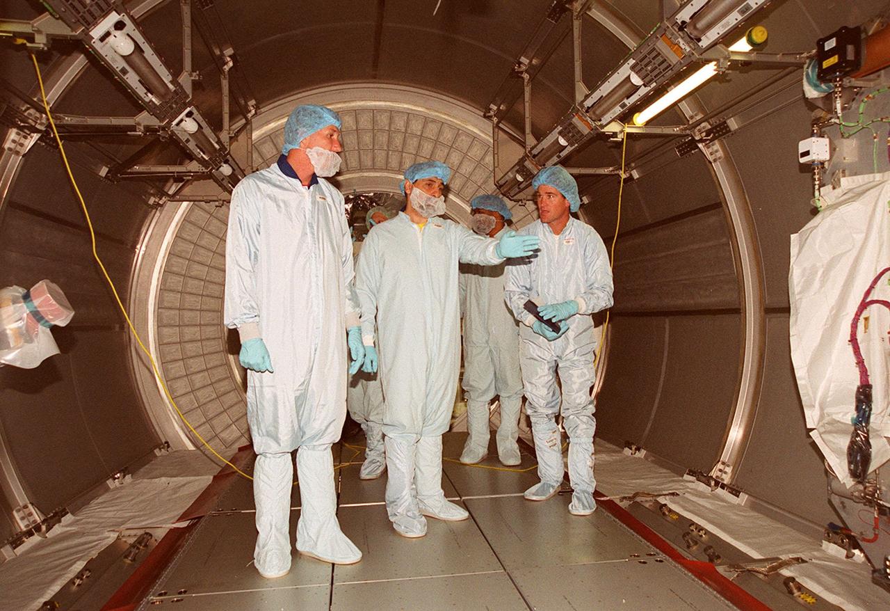 STS-100 Commander Kent Rominger and Mission Specialist Umberto Guidoni, who is with the European Space Agency, look over the inside of Raffaello, a Multi-Purpose Logistics Module. Mission STS-100, scheduled to launch April 19, 2001, will include Raffaello as well as the Space Station Remote Manipulator System (SSRMS) as its payload. MPLMs are pressurized modules that will serve as the International Space Station's “moving vans,” carrying laboratory racks filled with equipment, experiments and supplies to and from the station aboard the Space Shuttle. The SSRMS is the primary means of transferring payloads between the orbiter payload bay and the International Space Station for assembly