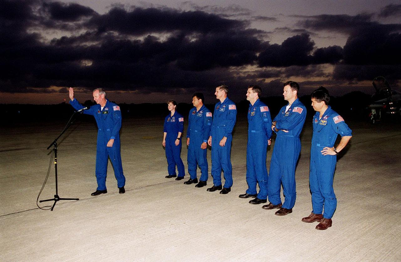 Gathered on the parking apron at the Shuttle Landing Facility after their arrival is the STS-92 crew. Commander Brian Duffy waves to the media (out of view) before heading to the bus for the short trip to crew quarters at the Operations and Checkout Building. Standing behind Duffy are (left to right) Pilot Pamela Ann Melroy and Mission Specialists Leroy Chiao, William S. McArthur Jr., Peter J.K. “Jeff” Wisoff, Michael E. Lopez-Alegria and Koichi Wakata of Japan. The mission is the fifth flight for the construction of the International Space Station. The payload includes the Integrated Truss Structure Z-1 and the third Pressurized Mating Adapter. During the 11-day mission, four extravehicular activities (EVAs), or space walks, are planned