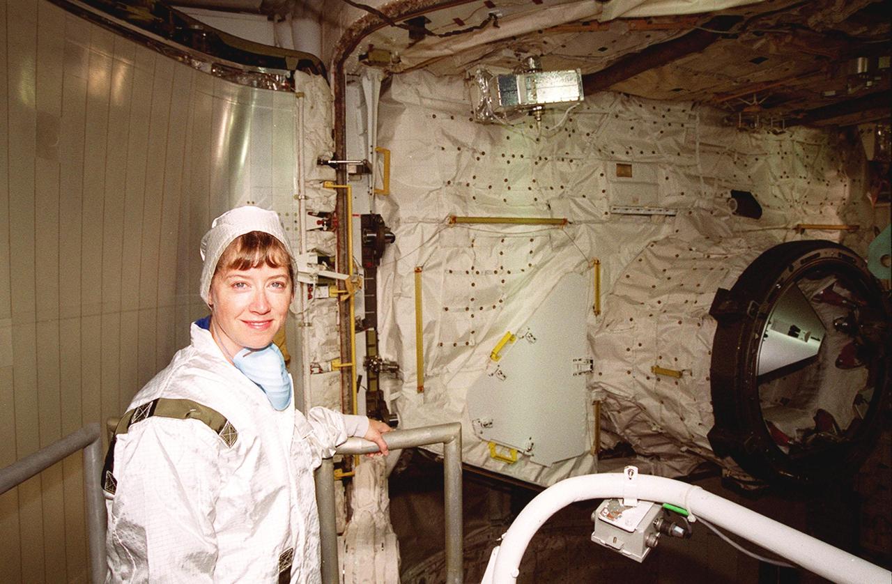 STS-92 Pamela Ann Melroy pauses during inspection of the payload (behind her) in Space Shuttle Discovery’s payload bay. She and other crew members Commander Brian Duffy and Mission Specialists Koichi Wakata of Japan, Leroy Chiao, Peter J.K. “Jeff” Wisoff. Michael E. Lopez-Alegria and William S. McArthur Jr. are preparing for launch on Oct. 5, 2000. The mission is the fifth flight for the construction of the International Space Station. The payload includes the Integrated Truss Structure Z-1 and the third Pressurized Mating Adapter. During the 11-day mission, four extravehicular activities (EVAs), or space walks, are planned