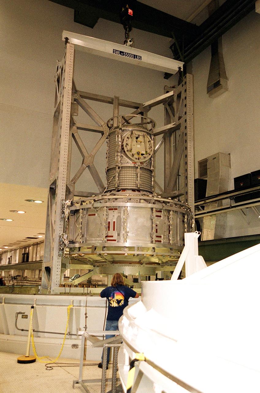 KENNEDY SPACE CENTER, FLA. -- In the Operations and Checkout Building, the Joint Airlock Module is suspended in air after being removed from the vacuum chamber where it was tested for leaks. The module was in a vacuum environment equivalent to 210,000 feet or 40 miles in altitude. It will be placed in a payload canister and taken to the Space Station Processing Facility. There it will continue to undergo preflight processing for the STS-104 mission scheduled for launch aboard Space Shuttle Atlantis May 17, 2001. The Joint Airlock Module is the gateway from which crew members aboard the International Space Station will enter and exit the 470-ton orbiting research facility