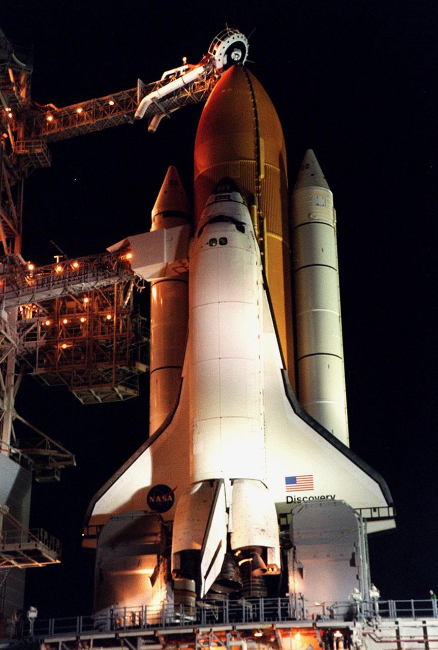 KENNEDY SPACE CENTER, Fla. --  After rollback of the Rotating Service Structure in the early morning hours, Space Shuttle Discovery stands ready for launch of mission STS-92. Above the external tank can be seen the Gaseous Oxygen Vent Arm with its vent hood, commonly referred to as the “beanie cap.” The system is designed to vent gaseous oxygen vapors away from the Shuttle after cryogenic loading. The scheduled launch is the second attempt after an earlier scrub. STS-92 is making the fifth flight for construction of the International Space Station. The mission is also the 100th in the history of the Shuttle program