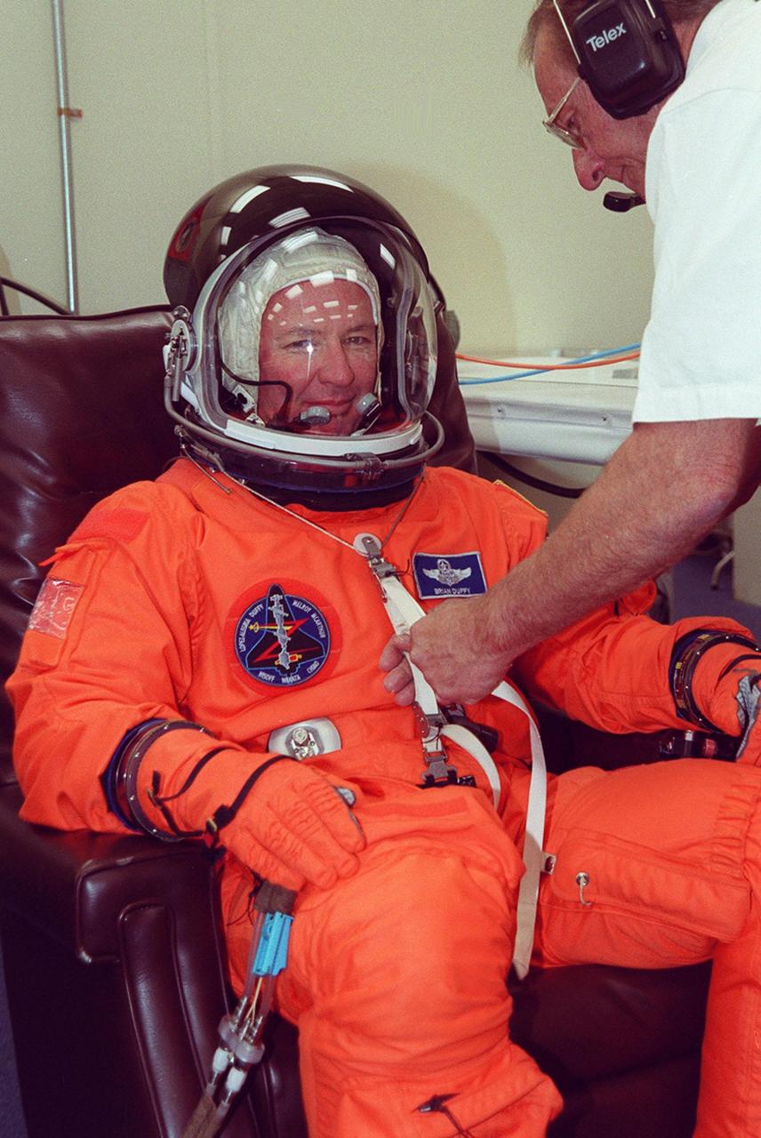 STS-92 Commander Brian Duffy has his launch and entry suit checked before launch, scheduled for 8:05 p.m. EDT. The mission is the fifth flight for the construction of the ISS. The payload includes the Integrated Truss Structure Z-1 and the third Pressurized Mating Adapter. During the 11-day mission, four extravehicular activities (EVAs), or spacewalks, are planned. The Z-1 truss is the first of 10 that will become the backbone of the International Space Station, eventually stretching the length of a football field. PMA-3 will provide a Shuttle docking port for solar array installation on the sixth ISS flight and Lab installation on the seventh ISS flight. This launch is the fourth for Duffy. Landing is expected Oct. 21 at 3:55 p.m. EDT