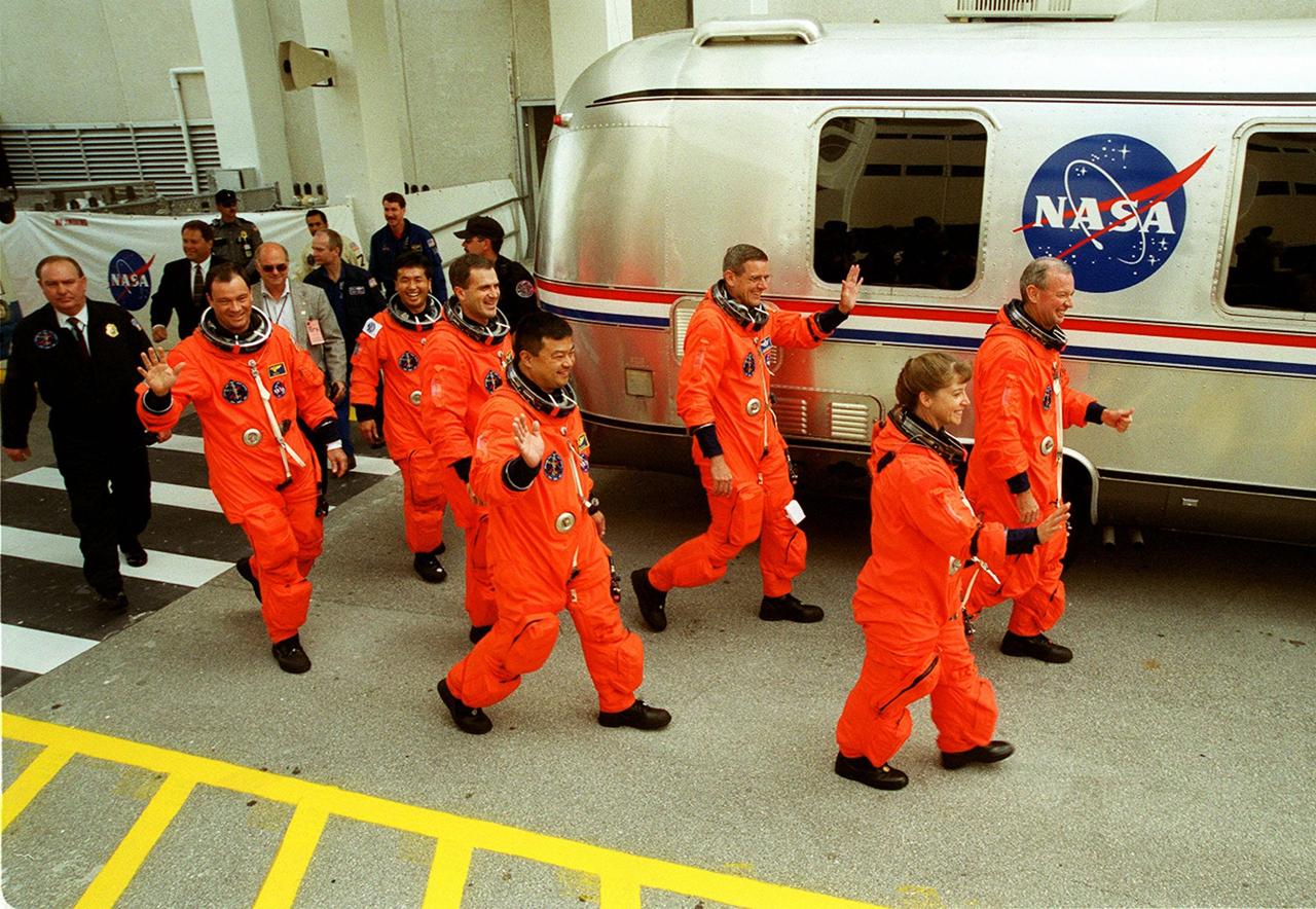 Striding happily to the waiting Astrovan for the trip to Launch Pad 39A are (left to right) STS-92 Mission Specialists Michael E. Lopez-Alegria, Koichi Wakata of Japan, Peter J.K. “Jeff” Wisoff, Leroy Chiao and William S. McArthur; Pilot Pamela Ann Melroy; and Commander Brian Duffy. STS-92 is scheduled for liftoff to the International Space Station (ISS) at 8:05 p.m. EDT. The mission is the fifth flight for the construction of the ISS. The payload includes the Integrated Truss Structure Z-1 and the third Pressurized Mating Adapter. During the 11-day mission, four extravehicular activities (EVAs), or spacewalks, are planned. The Z-1 truss is the first of 10 that will become the backbone of the International Space Station, eventually stretching the length of a football field. PMA-3 will provide a Shuttle docking port for solar array installation on the sixth ISS flight and Lab installation on the seventh ISS flight. Landing is expected Oct. 21 at 3:55 p.m. EDT
