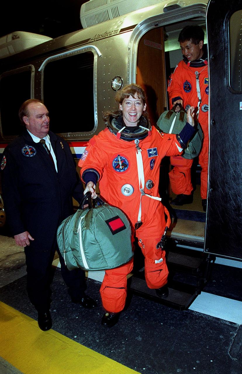 STS-92 Pilot Pamela Ann Melroy exits the Astrovan on its return to the Operations and Checkout Building. Behind her is Mission Specialist Koichi Wakata of Japan. The scheduled launch to the International Space Station (ISS) was scrubbed about 90 minutes before liftoff. The mission will be the fifth flight for the construction of the ISS. The payload includes the Integrated Truss Structure Z-1 and the third Pressurized Mating Adapter. During the 11-day mission, four extravehicular activities (EVAs), or spacewalks, are planned. The Z-1 truss is the first of 10 that will become the backbone of the International Space Station, eventually stretching the length of a football field. PMA-3 will provide a Shuttle docking port for solar array installation on the sixth ISS flight and Lab installation on the seventh ISS flight. The launch has been rescheduled for liftoff Oct. 11 at 7:17 p.m