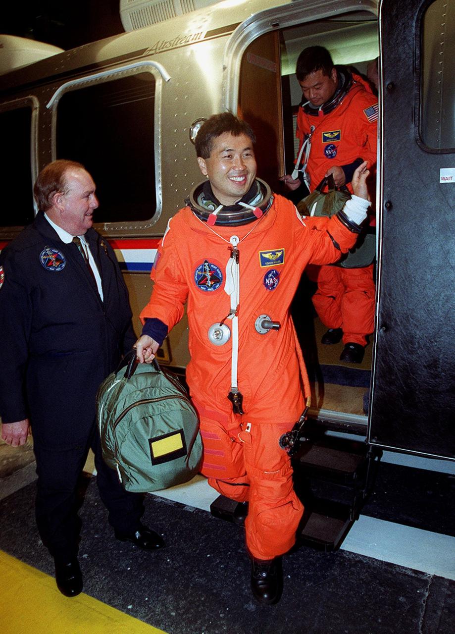 STS-92 Mission Specialist Koichi Wakata of Japan exits the Astrovan on its return to the Operations and Checkout Building. Behind him is Mission Specialist Leroy Chiao. The scheduled launch to the International Space Station (ISS) was scrubbed about 90 minutes before liftoff. The mission will be the fifth flight for the construction of the ISS. The payload includes the Integrated Truss Structure Z-1 and the third Pressurized Mating Adapter. During the 11-day mission, four extravehicular activities (EVAs), or spacewalks, are planned. The Z-1 truss is the first of 10 that will become the backbone of the International Space Station, eventually stretching the length of a football field. PMA-3 will provide a Shuttle docking port for solar array installation on the sixth ISS flight and Lab installation on the seventh ISS flight. The launch has been rescheduled for liftoff Oct. 11 at 7:17 p.m