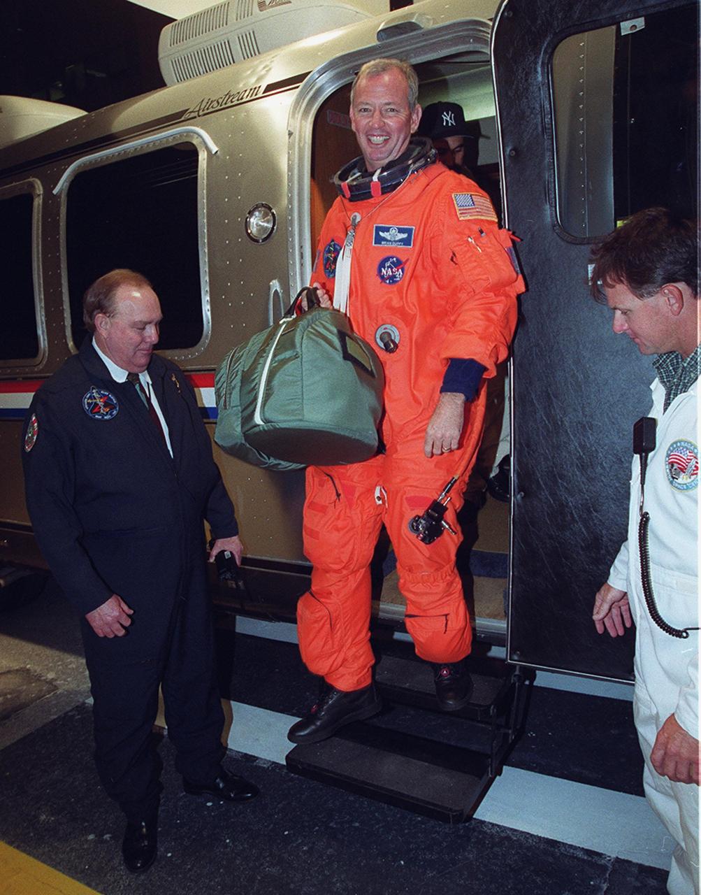 STS-92 Commander Brian Duffy pauses in the door of the Astrovan before exiting at the Operations and Checkout Building. The vehicle is returning the crew after the scheduled launch to the International Space Station (ISS) was scrubbed about 90 minutes before liftoff. The mission will be the fifth flight for the construction of the ISS. The payload includes the Integrated Truss Structure Z-1 and the third Pressurized Mating Adapter. During the 11-day mission, four extravehicular activities (EVAs), or spacewalks, are planned. The Z-1 truss is the first of 10 that will become the backbone of the International Space Station, eventually stretching the length of a football field. PMA-3 will provide a Shuttle docking port for solar array installation on the sixth ISS flight and Lab installation on the seventh ISS flight. The launch has been rescheduled for liftoff Oct. 11 at 7:17 p.m