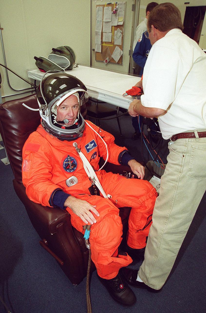 In the Operations and Checkout Building, STS-92 Commander Brian Duffy solemnly undergoes suit check before heading out to the Astrovan for the ride to Launch Pad 39A. During the 11-day mission to the International Space Station, four extravehicular activities (EVAs), or spacewalks, are planned for construction. The payload includes the Integrated Truss Structure Z-1 and the third Pressurized Mating Adapter. The Z-1 truss is the first of 10 that will become the backbone of the Space Station, eventually stretching the length of a football field. PMA-3 will provide a Shuttle docking port for solar array installation on the sixth Station flight and Lab installation on the seventh Station flight. Launch is scheduled for 7:17 p.m. EDT. Landing is expected Oct. 22 at 2:10 p.m. EDT