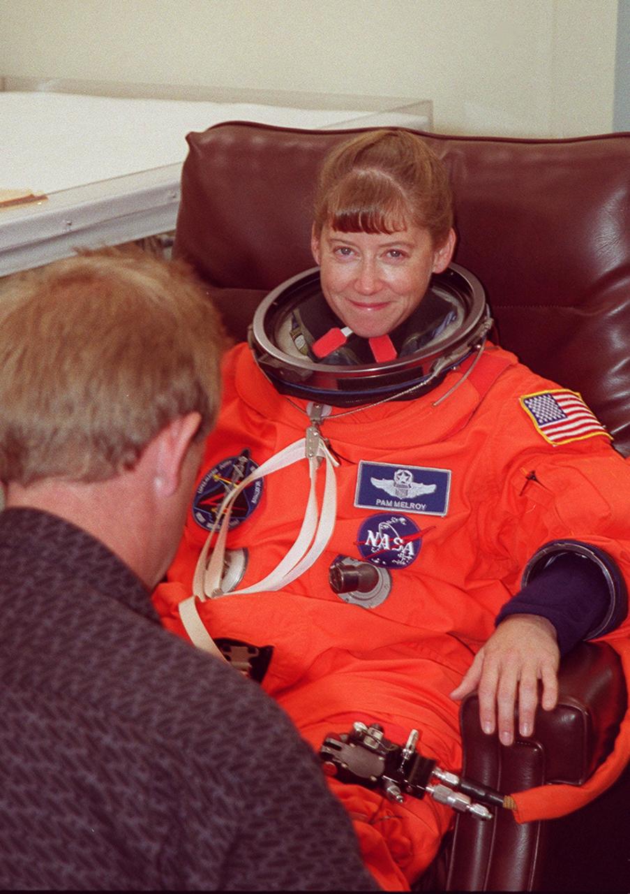 In the Operations and Checkout Building, STS-92 Pilot Pamela Ann Melroy smiles during suit check before heading out to the Astrovan for the ride to Launch Pad 39A. During the 11-day mission to the International Space Station, four extravehicular activities (EVAs), or spacewalks, are planned for construction. The payload includes the Integrated Truss Structure Z-1 and the third Pressurized Mating Adapter. The Z-1 truss is the first of 10 that will become the backbone of the Space Station, eventually stretching the length of a football field. PMA-3 will provide a Shuttle docking port for solar array installation on the sixth Station flight and Lab installation on the seventh Station flight. Launch is scheduled for 7:17 p.m. EDT. Landing is expected Oct. 22 at 2:10 p.m. EDT