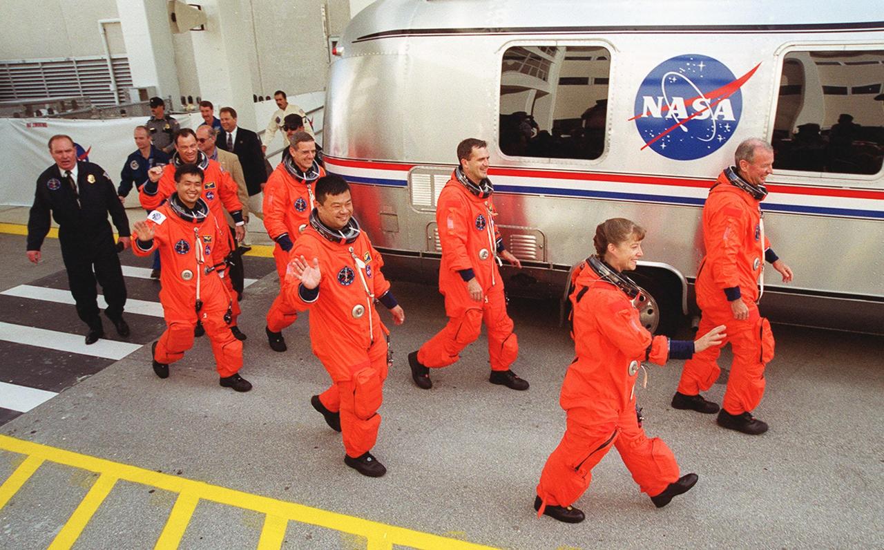 Eager to get to the launch pad and liftoff of Space Shuttle Discovery on mission STS-92, the crew hurries to the waiting Astrovan for the trip. From left are Mission Specialists Michael E. Lopez-Alegria, Koichi Wakata of Japan, William S. McArthur Jr., Leroy Chiao and Peter J.K. “Jeff” Wisoff; Pilot Pamela Ann Melroy; and Commander Brian Duffy. This launch is the fourth for Duffy and Wisoff, the third for Chiao and McArthur, second for Wakata and Lopez-Alegria, and first for Melroy. During the 11-day mission to the International Space Station, four extravehicular activities (EVAs), or spacewalks, are planned for construction. The payload includes the Integrated Truss Structure Z-1 and the third Pressurized Mating Adapter. The Z-1 truss is the first of 10 that will become the backbone of the Space Station, eventually stretching the length of a football field. PMA-3 will provide a Shuttle docking port for solar array installation on the sixth Station flight and Lab installation on the seventh Station flight. Launch is scheduled for 7:17 p.m. EDT. Discovery’s landing is expected Oct. 22 at 2:10 p.m. EDT