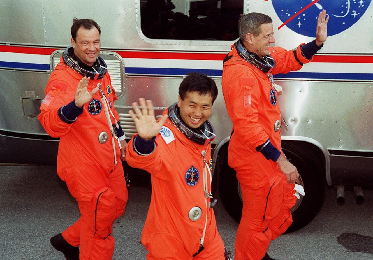 Three happy astronauts make their way to the waiting Astrovan that will take the STS-92 crew to Launch Pad 39A for liftoff of Space Shuttle Discovery. From left, they are Mission Specialists Michael Lopez-Alegria and Koichi Wakata, and Commander Brian Duffy. During the 11-day mission to the International Space Station, four extravehicular activities (EVAs), or spacewalks, are planned for construction. The payload includes the Integrated Truss Structure Z-1 and the third Pressurized Mating Adapter. The Z-1 truss is the first of 10 that will become the backbone of the Space Station, eventually stretching the length of a football field. PMA-3 will provide a Shuttle docking port for solar array installation on the sixth Station flight and Lab installation on the seventh Station flight. Launch is scheduled for 7:17 p.m. EDT. Discovery’s landing is expected Oct. 22 at 2:10 p.m. EDT