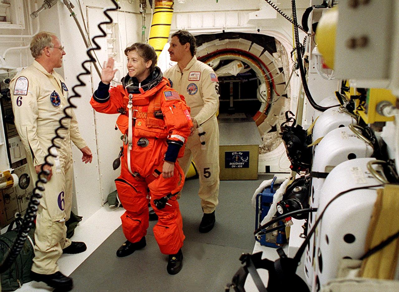 STS-92 Pilot Pamela Ann Melroy has a final check on her launch and entry suit in the White Room before entering Discovery. The White Room is an environmentally controlled area at the end of the Orbiter Access Arm that provides entry to the orbiter as well as emergency egress if needed. The arm remains in the extended position until 7 minutes 24 seconds before launch. Melroy and the rest of the crew are undertaking the fifth flight to the International Space Station for construction. Discovery carries a payload that includes the Integrated Truss Structure Z-1, first of 10 trusses that will form the backbone of the Space Station, and the third Pressurized Mating Adapter that will provide a Shuttle docking port for solar array installation on the sixth Station flight and Lab installation on the seventh Station flight. The mission includes four spacewalks for the construction activities. Discovery’s landing is expected Oct. 22 at 2:10 p.m. EDT