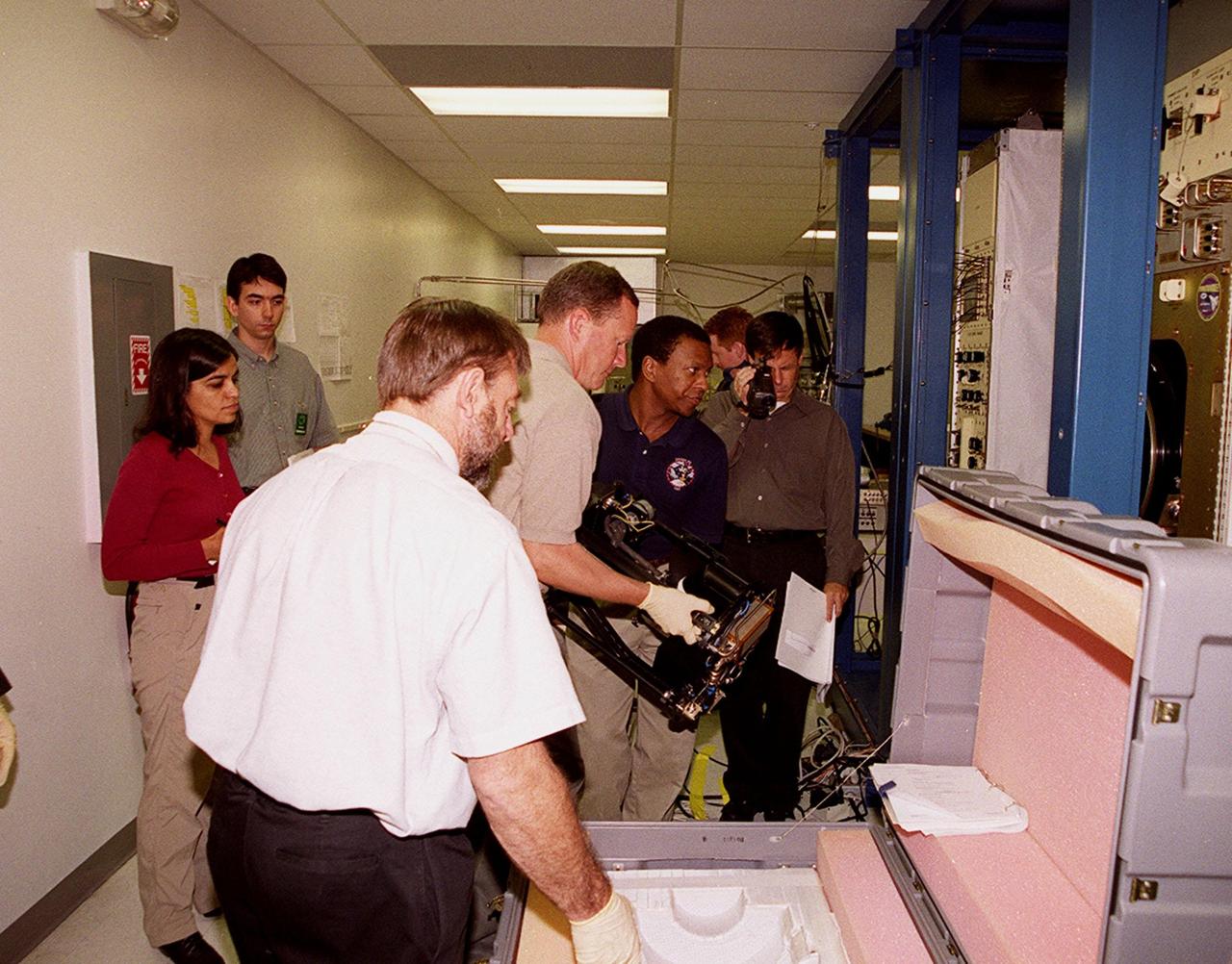 KENNEDY SPACE CENTER, FLA. -- At SPACEHAB, STS-107 crew members check out equipment for their mission. At the far left are Mission Specialists Kalpana Chawla and Ilan Ramon, who is from Israel. At center, handling the equipment, are Mission Specialists David Brown and Michael Anderson. Identified as a research mission, STS-107 is scheduled for launch July 19, 2001