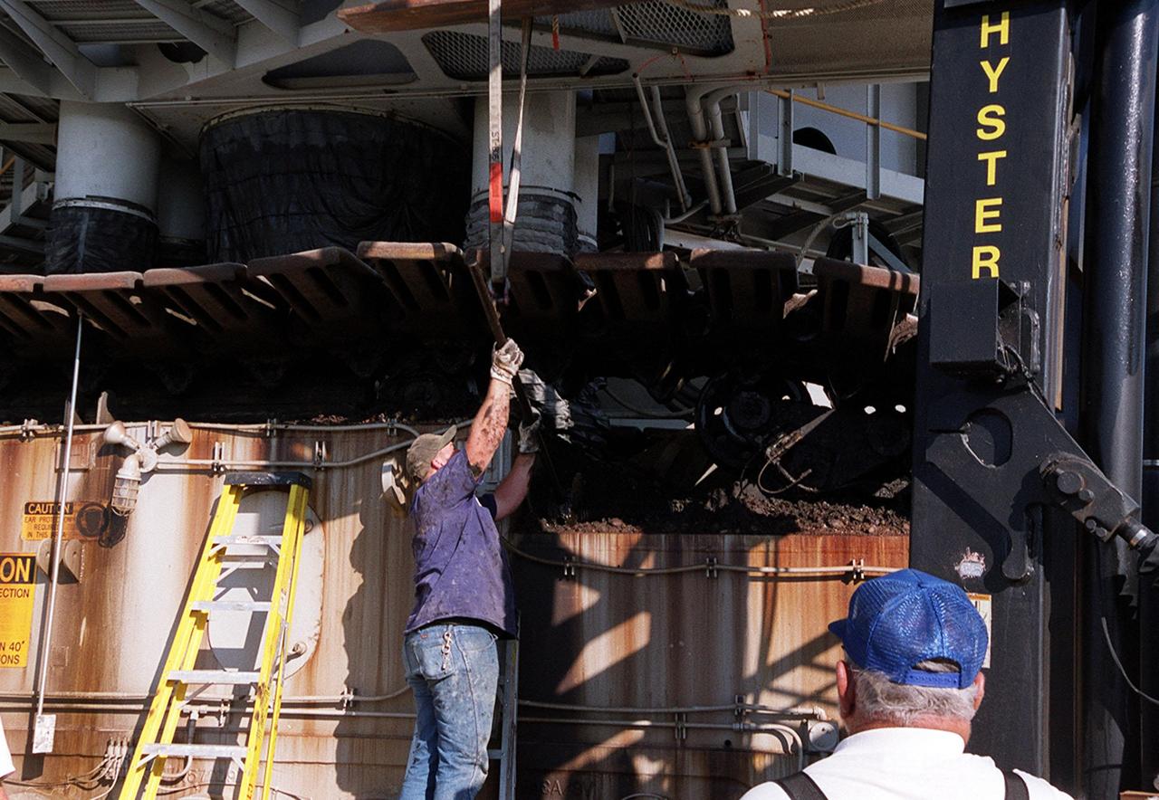 KENNEDY SPACE CENTER, FLA. -- A worker adjusts equipment to remove a broken cleat (shoe) on the crawler-transporter moving the Space Shuttle Endeavour to Launch Pad 39B. The crack was noticed as the crawler-transporter started up the incline to the pad. Endeavour is scheduled to be launched Nov. 30 at 10:01 p.m. EST on mission STS-97, the sixth construction flight to the International Space Station. Its payload includes the P6 Integrated Truss Structure and a photovoltaic (PV) module, with giant solar arrays that will provide power to the Station. The mission includes two spacewalks to complete the solar array connections