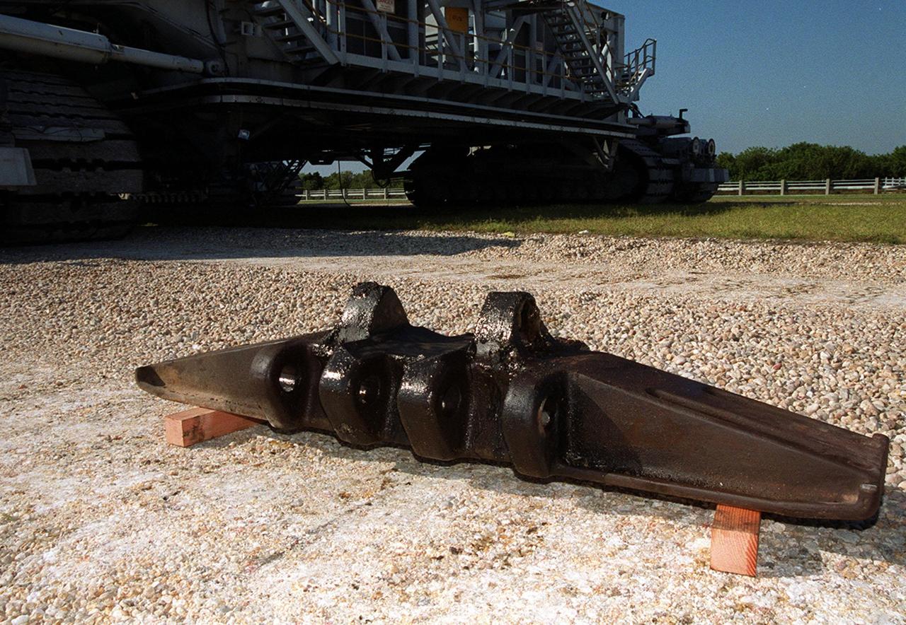 A new cleat, or shoe, for one of the tracks on the crawler-transporter sits on the ground near the vehicle (in the background). A cracked cleat was noticed on the crawler as it was rolling Space Shuttle Endeavour and the Mobile Launcher Platform out to Launch Pad 39B. The rollout is being suspended while the cleat is replaced. Endeavour is scheduled to be launched Nov. 30 at 10:01 p.m. EST on mission STS-97, the sixth construction flight to the International Space Station. Its payload includes the P6 Integrated Truss Structure and a photovoltaic (PV) module, with giant solar arrays that will provide power to the Station. The mission includes two spacewalks to complete the solar array connections