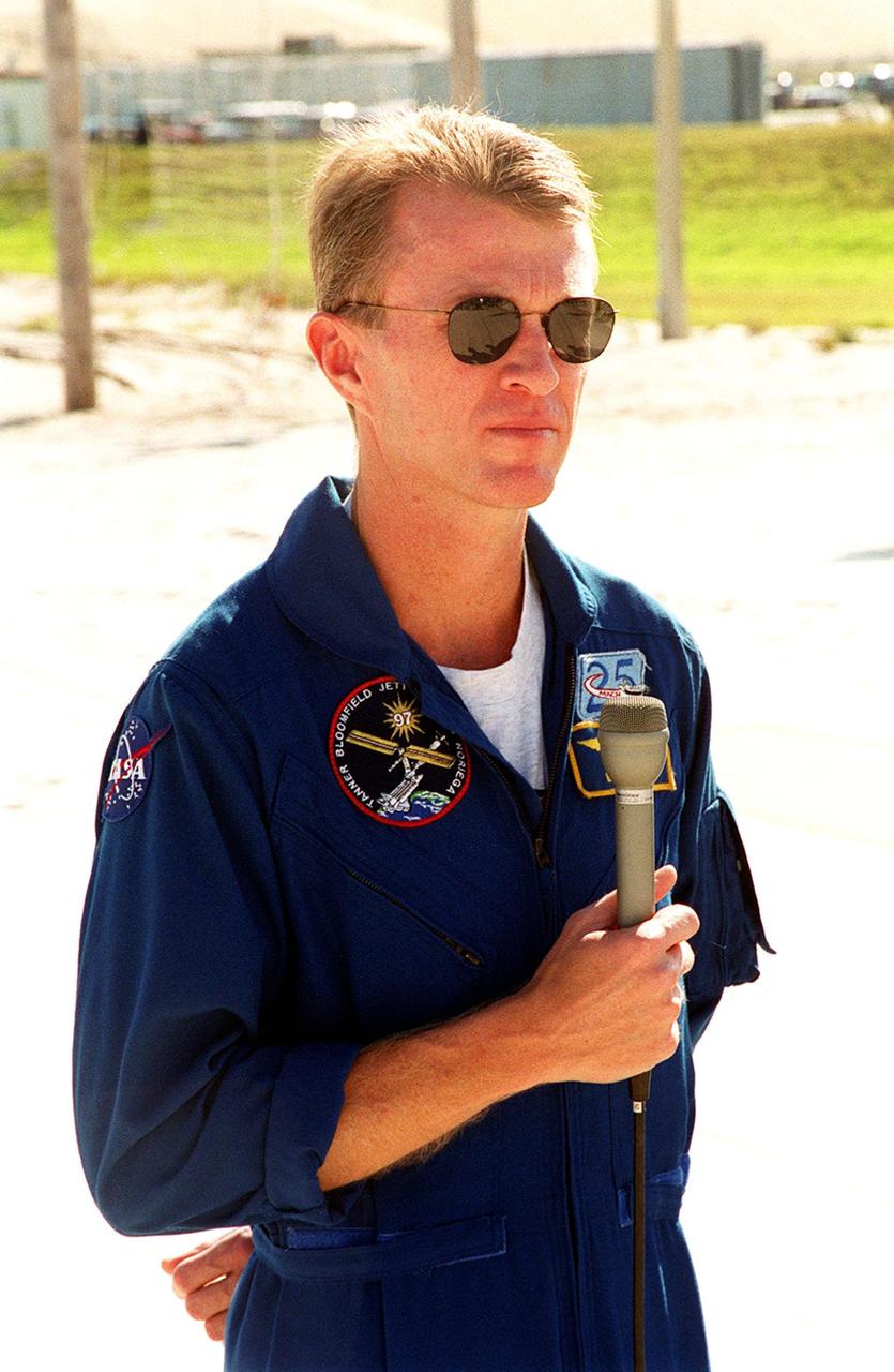 KENNEDY SPACE CENTER, Fla. -- STS-97 Commander Brent Jett listens to a question from a reporter during a media session near Launch Pad 39B. The crew is at KSC to take part in Terminal Countdown Demonstration Test activities that include emergency egress training, familiarization with the payload, and a simulated launch countdown. The other crew members are Pilot Mike Bloomfield and Mission Specialists Joe Tanner, Marc Garneau and Carlos Noriega. Garneau is with the Canadian Space Agency. Mission STS-97is the sixth construction flight to the International Space Station. Its payload includes the P6 Integrated Truss Structure and a photovoltaic (PV) module, with giant solar arrays that will provide power to the Station. The mission includes two spacewalks to complete the solar array connections. STS-97 is scheduled to launch Nov. 30 at about 10:05 p.m. EST