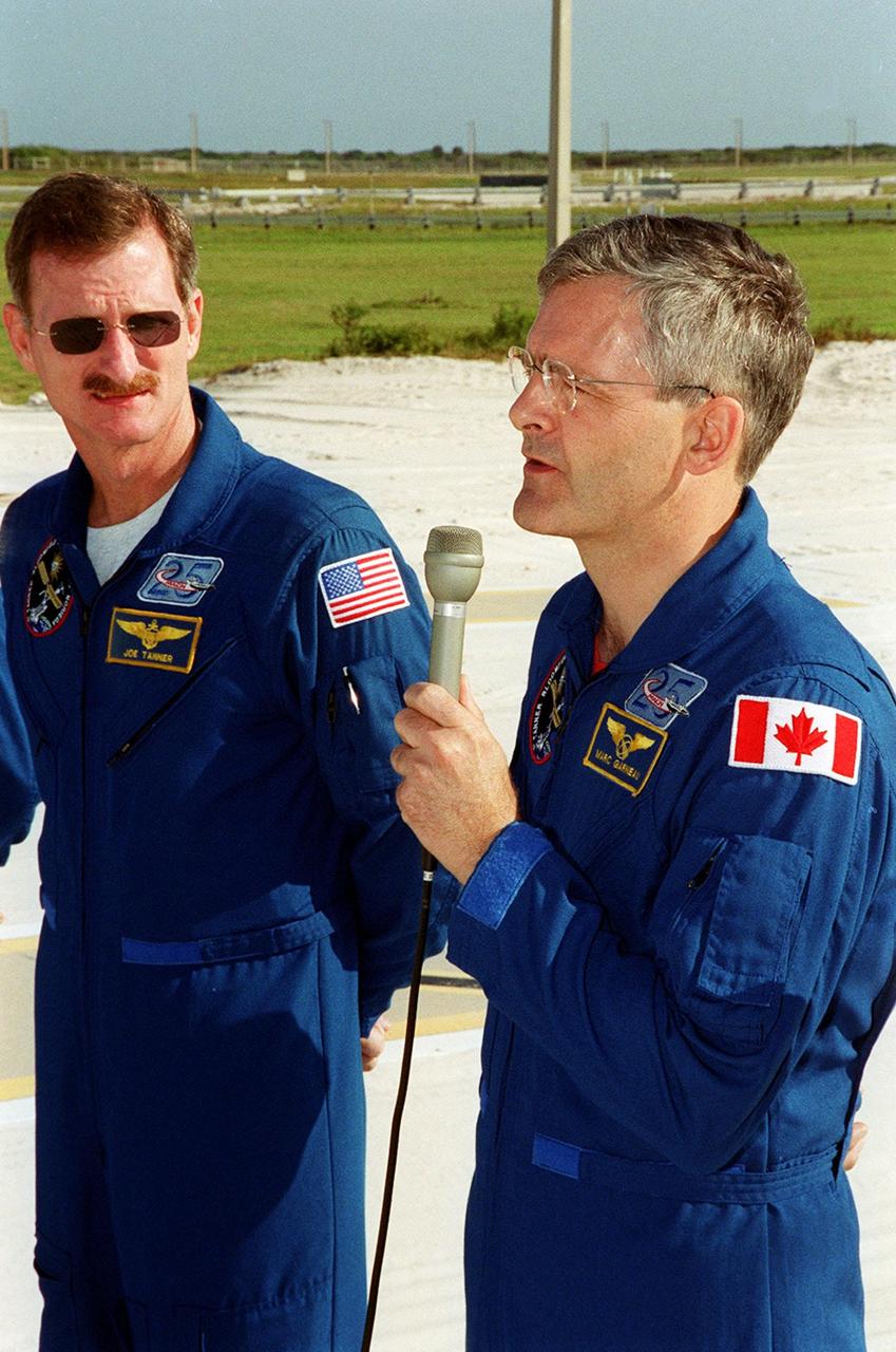 STS-97 Mission Specialist Marc Garneau (right) answers a question from the media. At left is Mission Specialist Joe Tanner. They and the other crew members are meeting with the media before beginning emergency egress training at Launch Pad 39B. The training is part of Terminal Countdown Demonstration Test activities that include a simulated launch countdown. Mission STS-97 is the sixth construction flight to the International Space Station. Its payload includes the P6 Integrated Truss Structure and a photovoltaic (PV) module, with giant solar arrays that will provide power to the Station. The mission includes two spacewalks to complete the solar array connections. STS-97 is scheduled to launch Nov. 30 at 10:05 p.m. EST
