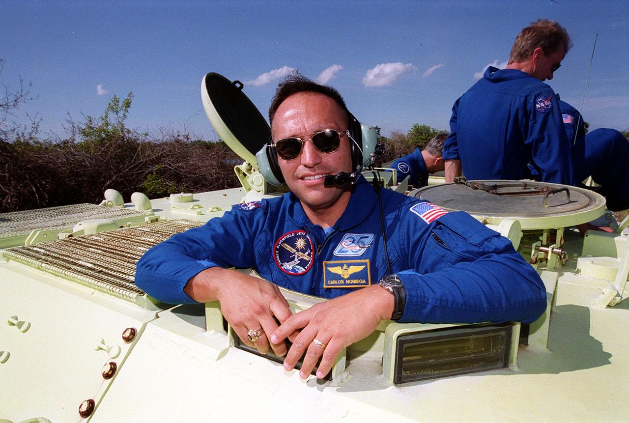 Mission Specialist Carlos Noriega (front) gets ready to take the wheel of an M-113. In the rear can be seen Mission Specialists Marc Garneau (left) and Joe Tanner (right). Learning to drive the armored vehicle is part of emergency egress training during Terminal Countdown Demonstration Test (TCDT) activities. The tracked vehicle could be used by the crew in the event of an emergency at the pad during which the crew must make a quick exit from the area. The TCDT, also includes a simulated launch countdown and opportunities to inspect the mission payloads in the orbiter’s payload bay. Mission STS-97is the sixth construction flight to the International Space Station. Its payload includes the P6 Integrated Truss Structure and a photovoltaic (PV) module, with giant solar arrays that will provide power to the Station. The mission includes two spacewalks to complete the solar array connections. STS-97 is scheduled to launch Nov. 30 at 10:05 p.m. EST