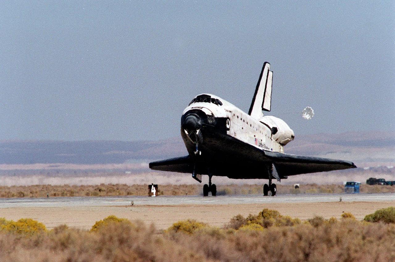 With its drag chute deployed, orbiter Discovery and its seven-member crew roll toward a stop at Edwards Air Force Base, Calif., after an 11-day mission to the International Space Station. The orbiter’s main landing gear touched down on EAFB runway 22 at 5 p.m. With the aid of its drag chute, Discovery came to a complete stop at 5:01 p.m. At the conclusion of mission STS-92, Discovery and crew had traveled about 5.3 million statute miles. Following vehicle safing and preliminary offloading efforts, workers will begin preparations for Discovery’s transcontinental ferry flight back to KSC on the back of NASA’s modified Boeing 747
