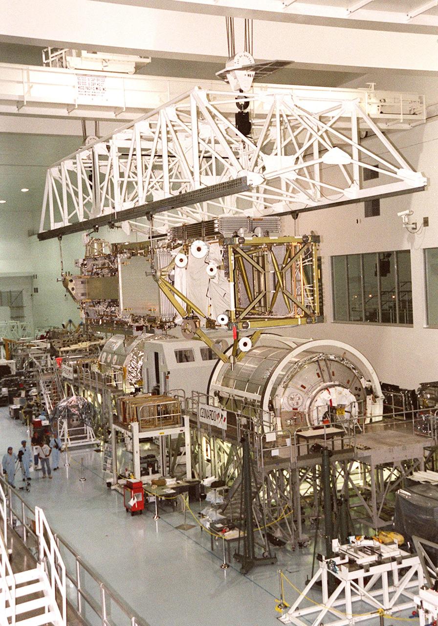 As it travels across the Space Station Processing Facility, the P6 integrated truss segment passes over the two Italian-built Multi-Purpose Logistics Modules, Leonardo (right) and Raffaello (behind Leonardo). The P6 is being moved to a payload transport canister for transfer to Launch Pad 39B. There it will be placed in Endeavour’s payload bay for launch on mission STS-97. The P6 comprises Solar Array Wing-3 and the Integrated Electronic Assembly, to be installed on the Space Station. The Station’s electrical power system will use eight photovoltaic solar arrays, each 112 feet long by 39 feet wide, to convert sunlight to electricity. The solar arrays are mounted on a “blanket” that can be folded like an accordion for delivery. Once in orbit, astronauts will deploy the blankets to their full size. Gimbals will be used to rotate the arrays so that they will face the Sun to provide maximum power to the Space Station. Launch is scheduled Nov. 30 at 10:06 p.m. EST