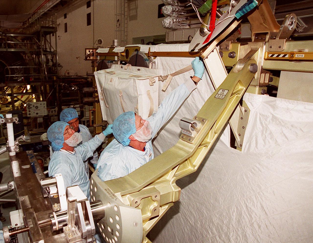 KENNEDY SPACE CENTER, FLA. -- In the Space Station Processing Facility, STS-97 Mission Specialists Carlos Noriega (far left) and Joe Tanner (right) check out the mission payload, the P6 integrated truss segment. Mission STS-97 is the sixth construction flight to the International Space Station. The P6 comprises Solar Array Wing-3 and the Integrated Electronic Assembly, to be installed on the International Space Station. The Station’s electrical power system will use eight photovoltaic solar arrays, each 112 feet long by 39 feet wide, to convert sunlight to electricity. The solar arrays are mounted on a “blanket” that can be folded like an accordion for delivery. Once in orbit, astronauts will deploy the blankets to their full size. Gimbals will be used to rotate the arrays so that they will face the Sun to provide maximum power to the Space Station. The mission includes two spacewalks by Noriega and Tanner to complete the solar array connections. STS-97 is scheduled to launch Nov. 30 at about 10:06 p.m. EST