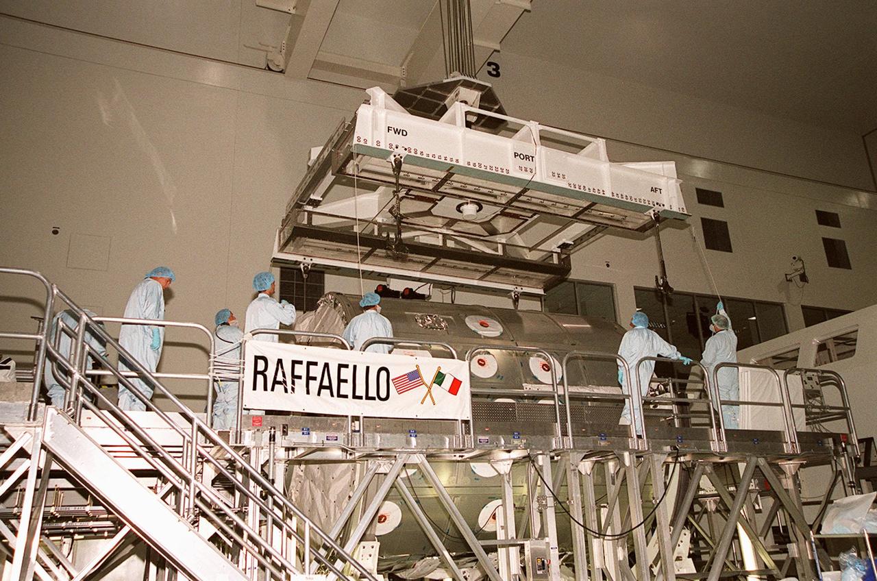 In the Space Station Processing Facility, an overhead frame is attached to the Italian-built Multi-Purpose Logistics Module “Raffaello.” The module will be lifted and moved to a weight-and-balance workstand. Rafaello is the payload on mission STS-100, a Lab outfitting flight. Raffaello carries six system racks and two storage racks for the U.S. Lab. Launch of STS-100 is scheduled for April 19, 2001
