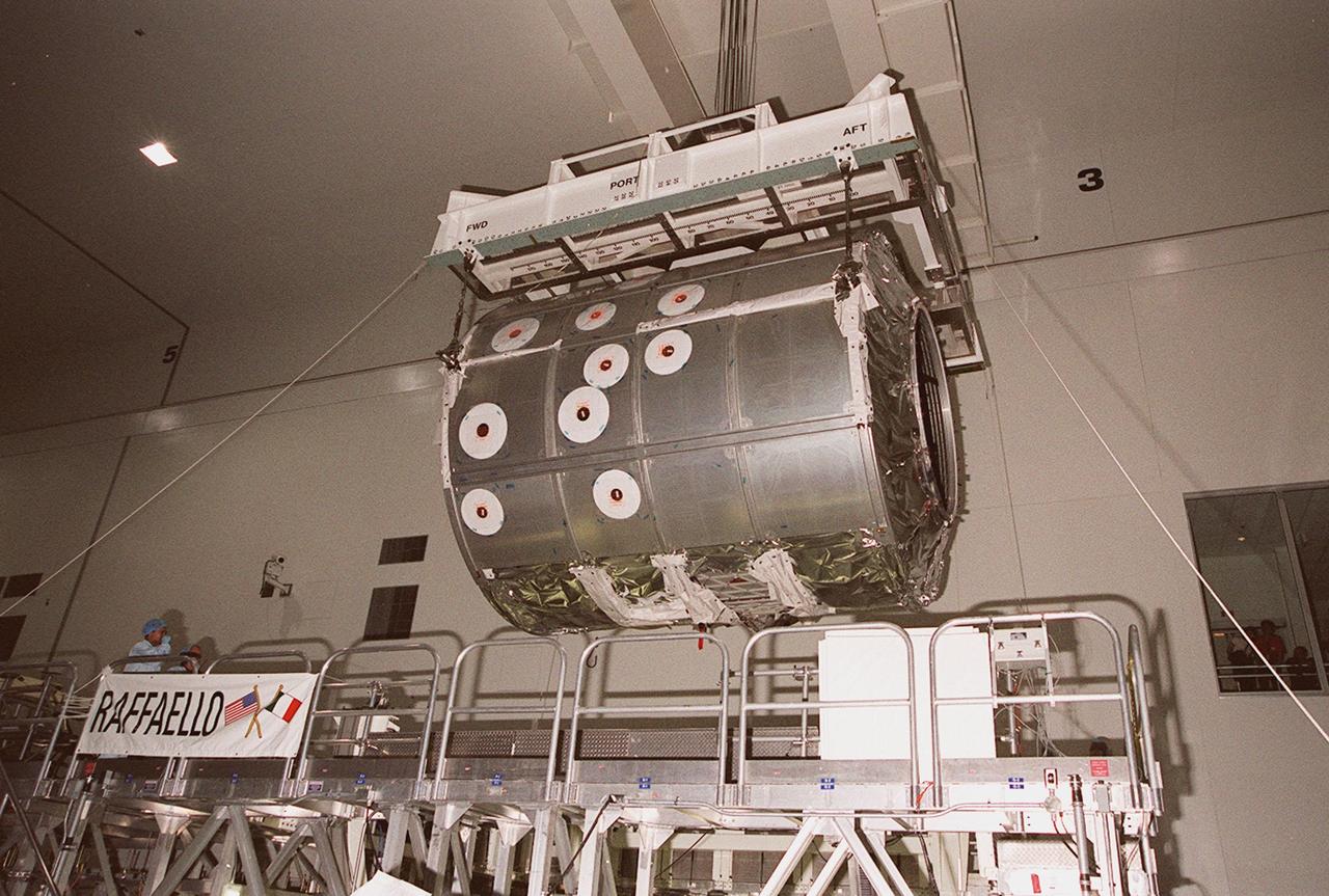 In the Space Station Processing Facility, an overhead frame lifts the Italian-built Multi-Purpose Logistics Module “Raffaello” off its workstand. The module is being moved to a weight-and-balance workstand. Rafaello is the payload on mission STS-100, a Lab outfitting flight. Raffaello carries six system racks and two storage racks for the U.S. Lab. Launch of STS-100 is scheduled for April 19, 2001