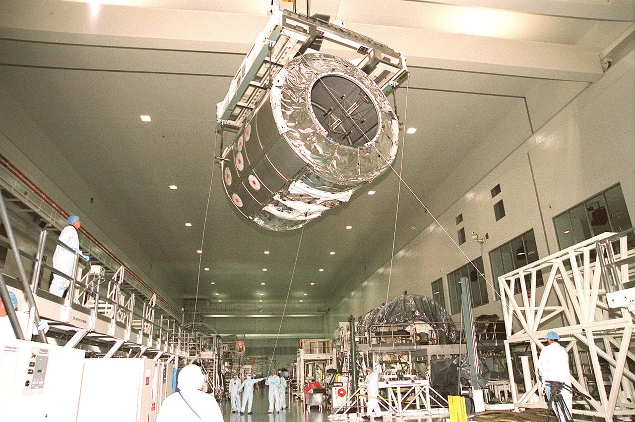 In the Space Station Processing Facility, an overhead frame moves the Italian-built Multi-Purpose Logistics Module “Raffaello” across the facility to a weight-and-balance workstand. Rafaello is the payload on mission STS-100, a Lab outfitting flight. Raffaello carries six system racks and two storage racks for the U.S. Lab. Launch of STS-100 is scheduled for April 19, 2001